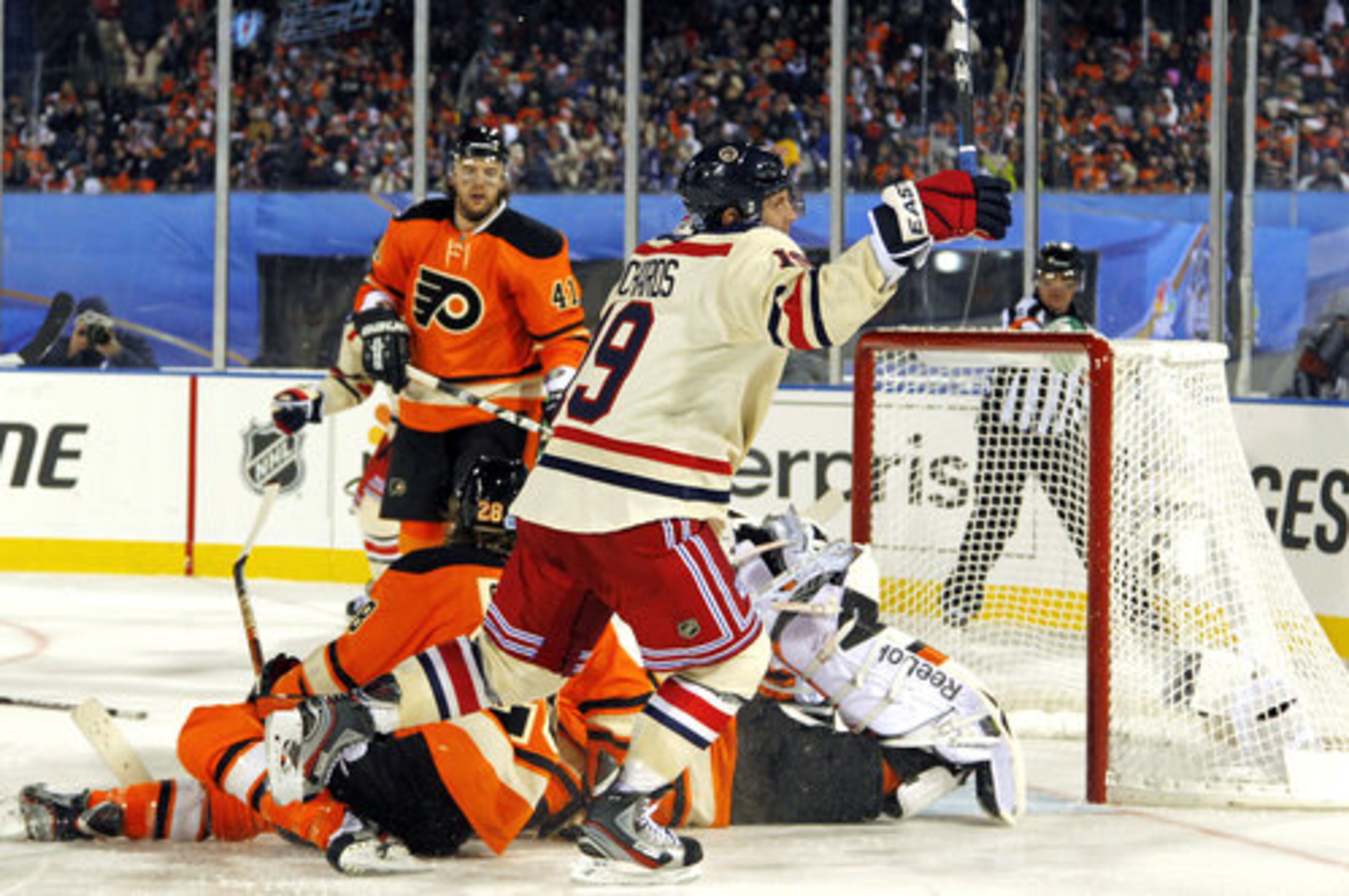 New York Rangers' Brad Richards (19) celebrates after scoring a goal past Philadelphia Flyers' Claude Giroux and goalie Sergei Bobrovsky in the third period of the NHL Winter Classic hockey game, Monday, Jan. 2, 2012, in Philadelphia.