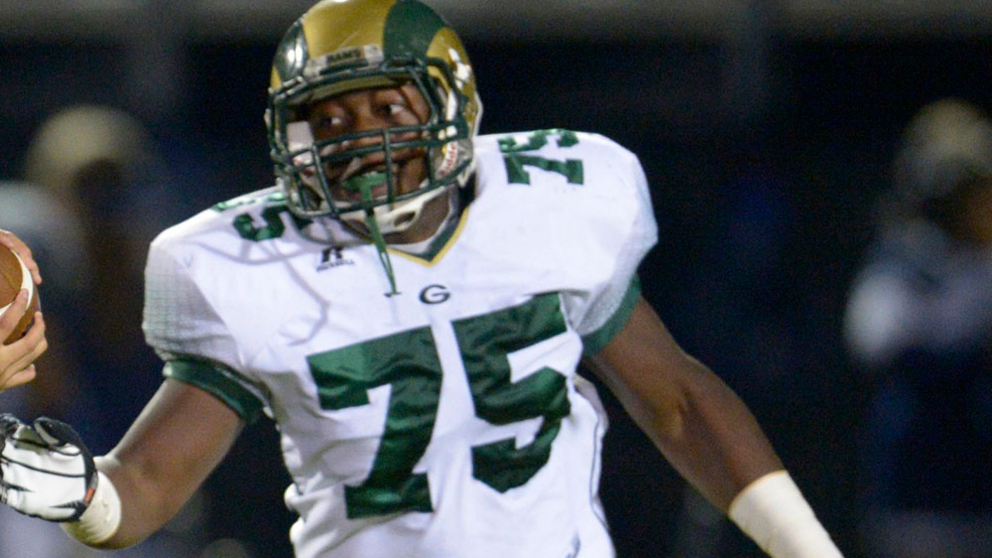 South Gwinnett quarterback Josh Shim (2) is tackled for a loss by Grayson's Chris Martin (75) and Zack Mooney (56) in the first half of their high school football game on Friday, Oct. 18, 2013, in Snellville, Ga. David Tulis / AJC Special