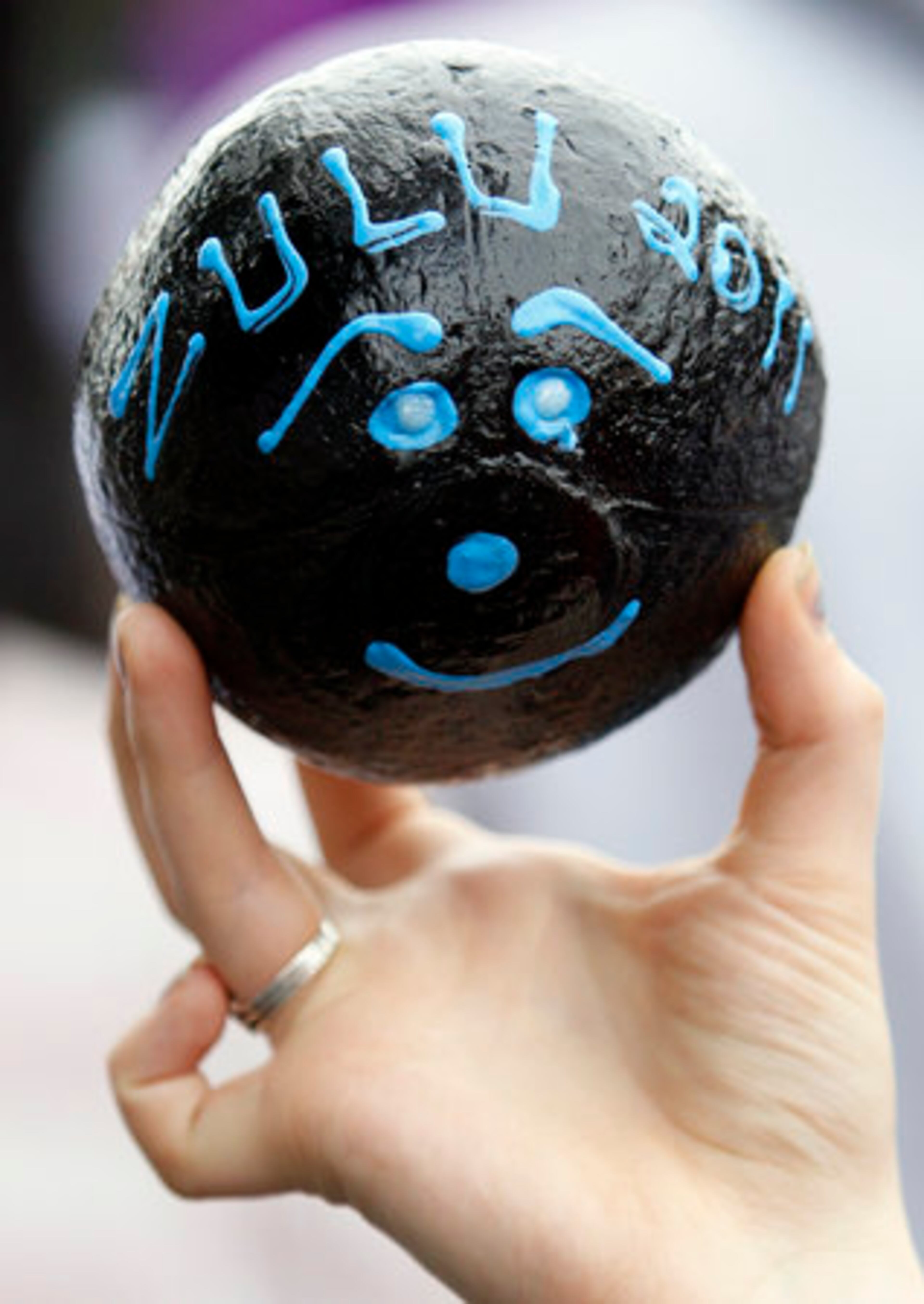 A reveler displays a decorated Zulu coconut, which is a prized Mardi Gras possession, that she received during the Zulu Social Aid and Pleasure Club parade.