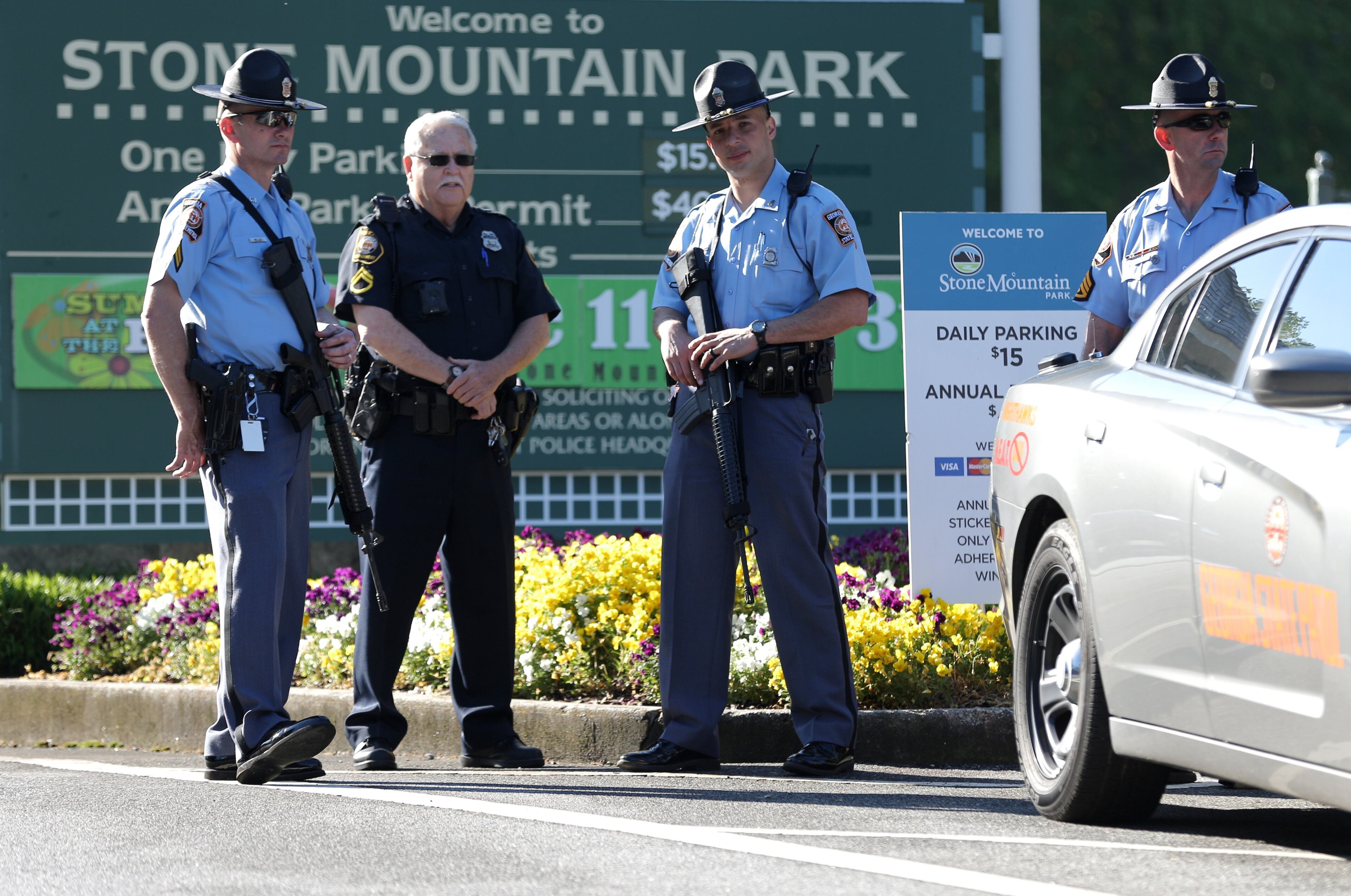 Georgia State Patrol troopers with long guns monitor the entrance to Stone Mountain Park on Saturday morning, April 23, 2016 where a white power protest and two counter protests were scheduled. Ben Gray / bgray@ajc.com