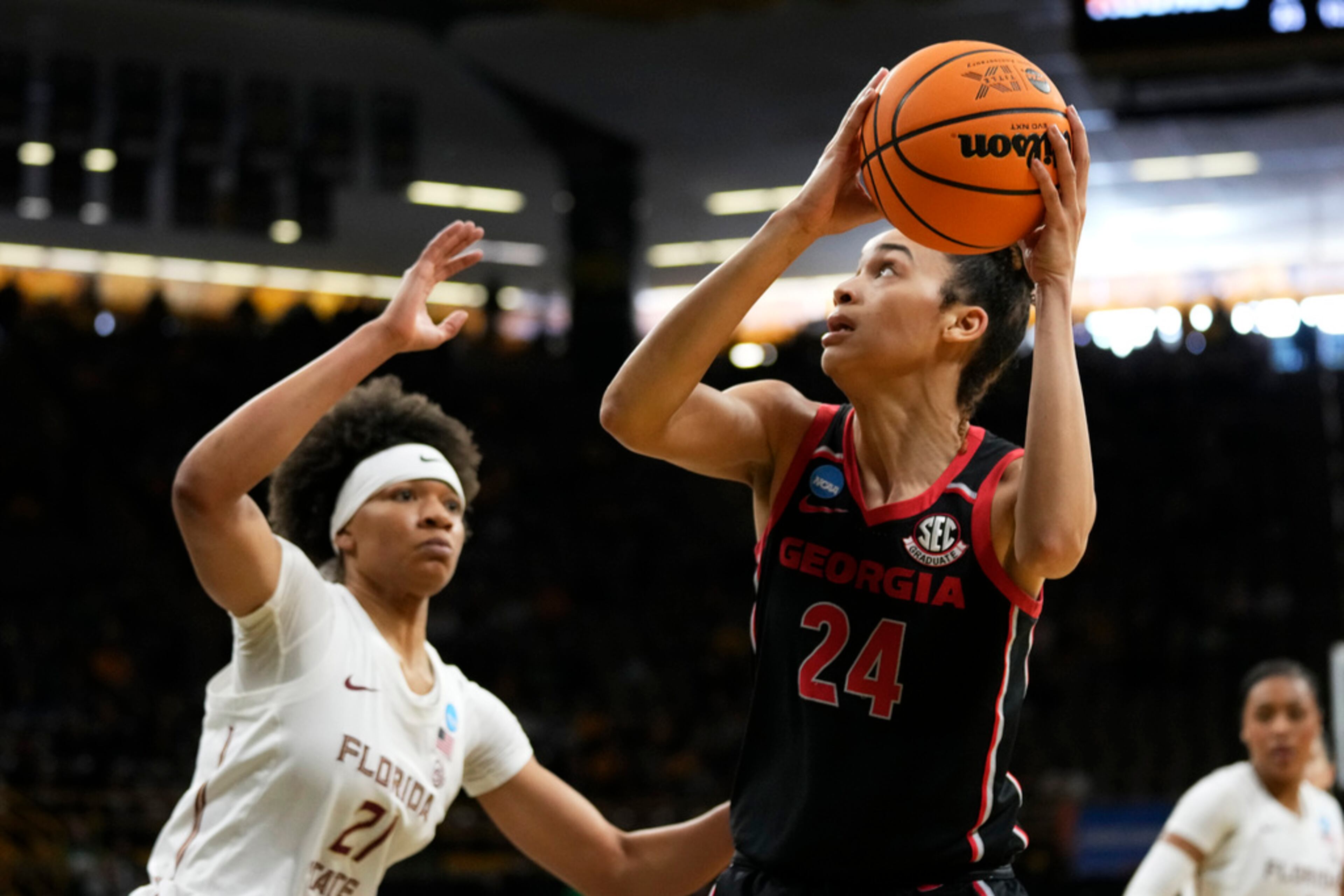 Georgia forward Brittney Smith (24) drives to the basket past Florida State forward Makayla Timpson (21) in the second half of a first-round college basketball game in the NCAA Tournament, Friday, March 17, 2023, in Iowa City, Iowa. (AP Photo/Charlie Neibergall)