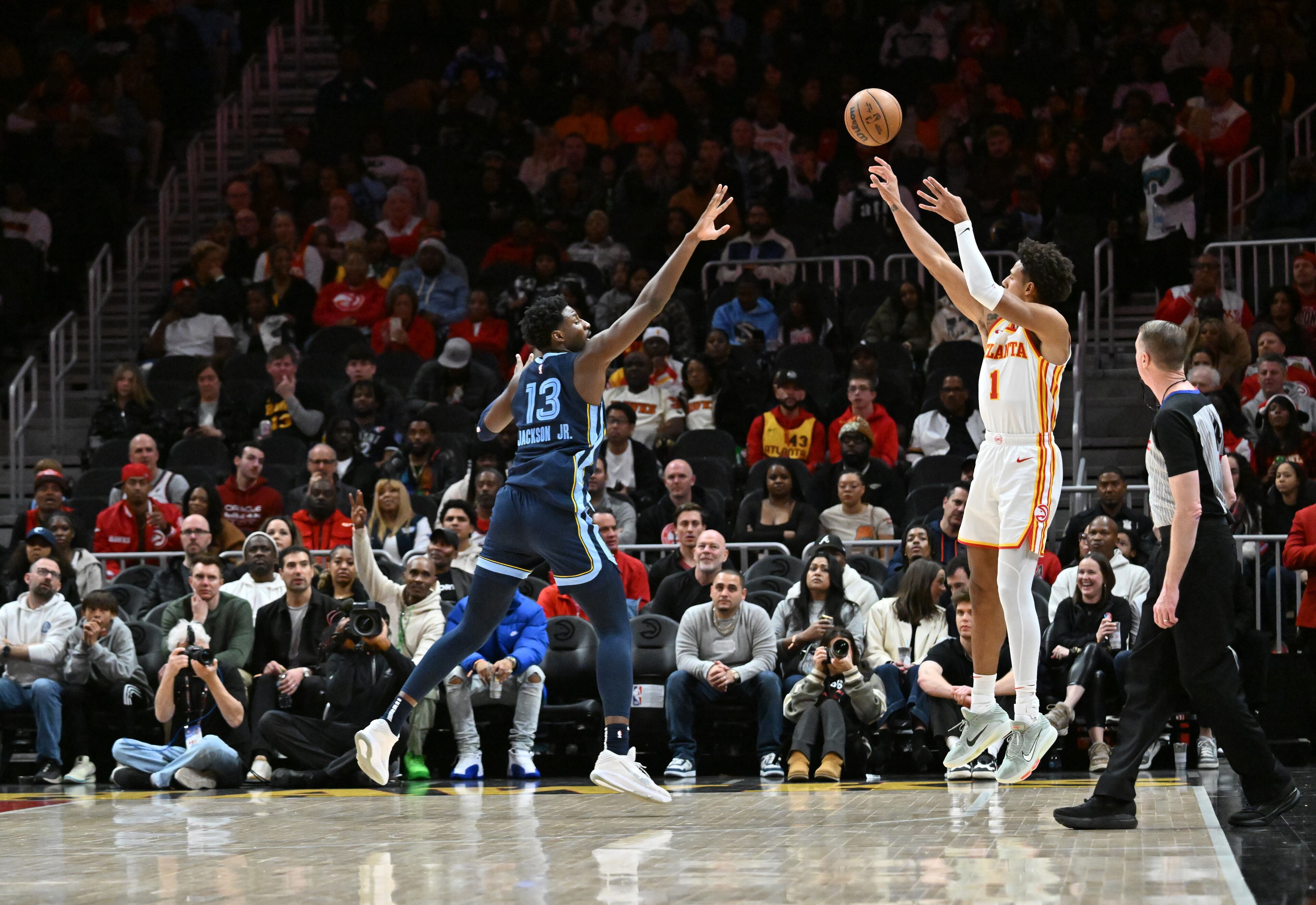 Atlanta Hawks forward Jalen Johnson (1) shoots a 3-point basket over Memphis Grizzlies forward Jaren Jackson Jr. (13) during the first half in an NBA basketball game at State Farm Arena, Saturday, December 21, 2024, in Atlanta. (Hyosub Shin / AJC)