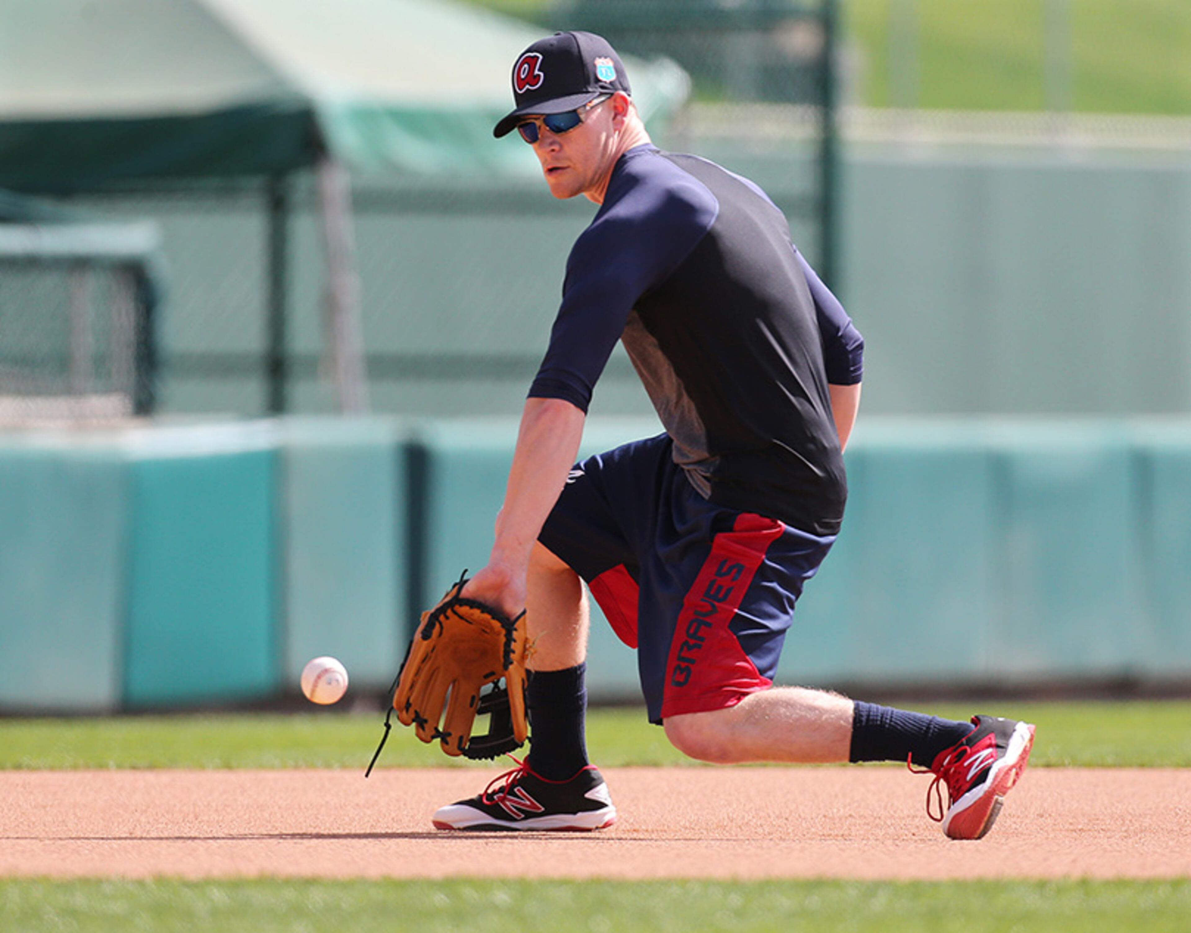 Braves infielder Gordon Beckham fields a grounder during spring training practice Monday at Champion Stadium.