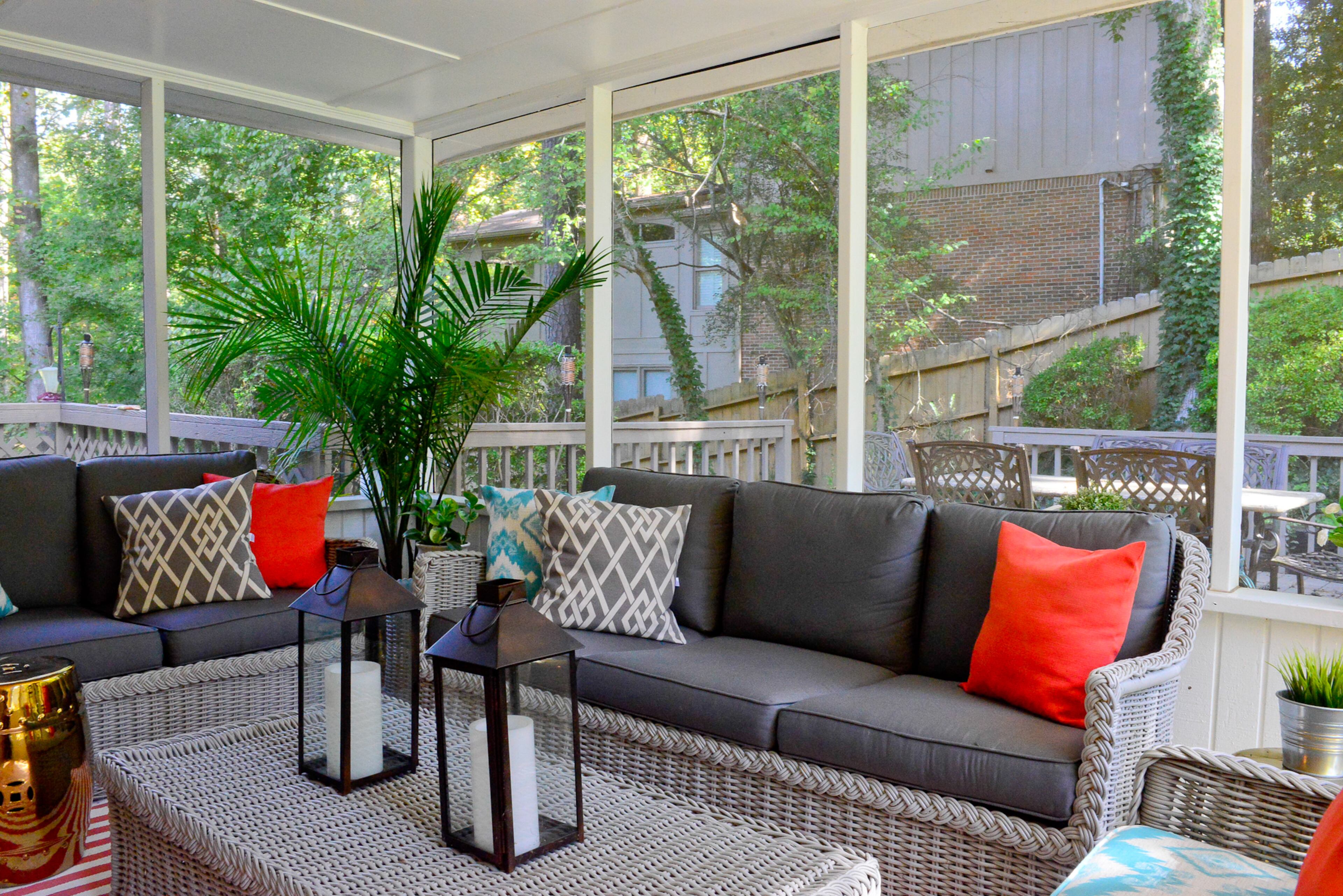 For a quick, cheap update, a set of wicker furniture left by the previous homeowners was repainted. Lauren Harris Interiors created new cushion covers for the screened porch pillows.
