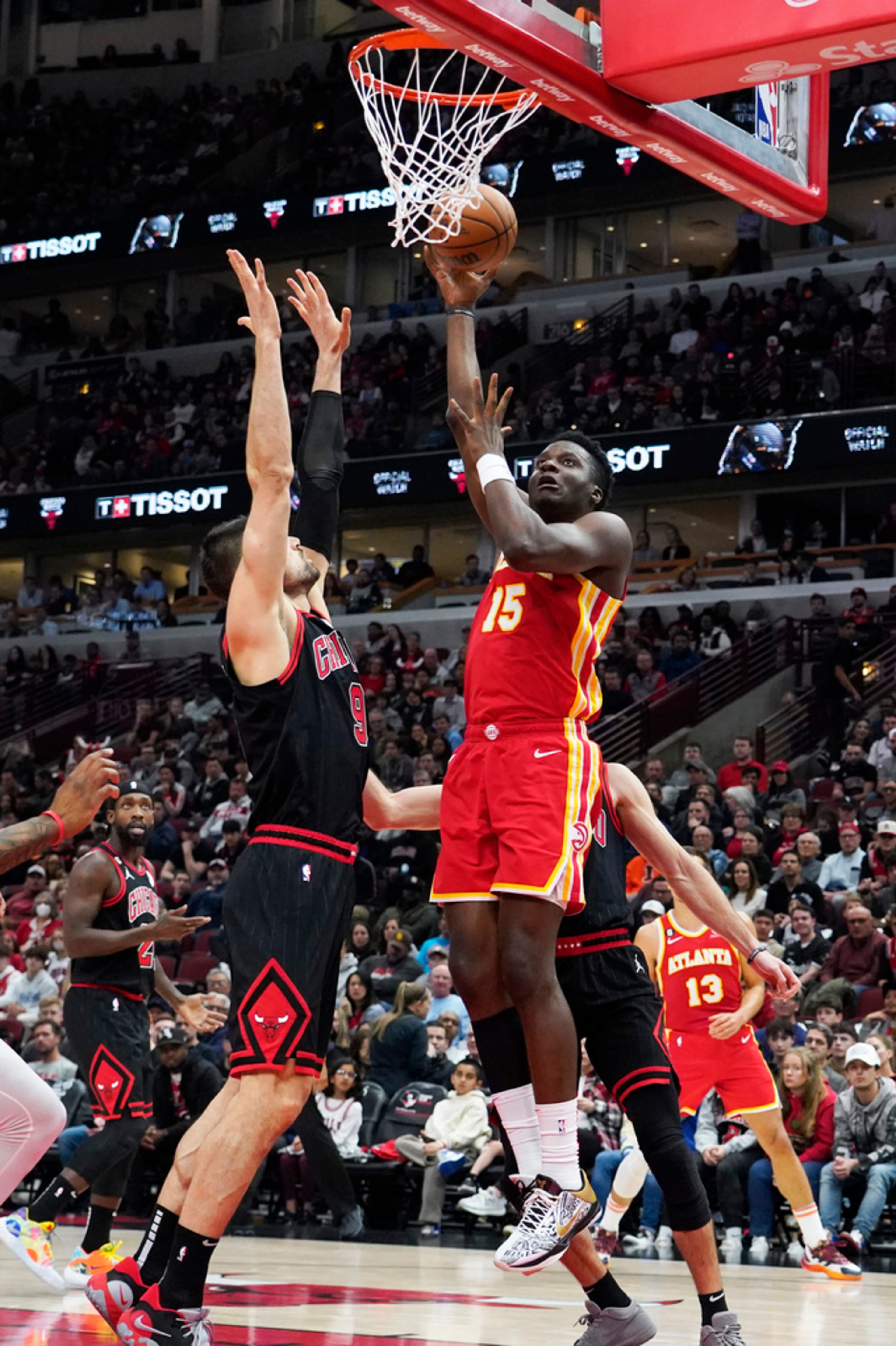 Atlanta Hawks center Clint Capela (15) shoots against Chicago Bulls center Nikola Vucevic (9) during the first quarter of an NBA basketball game Tuesday, April 4, 2023, in Chicago. (AP Photo/David Banks)