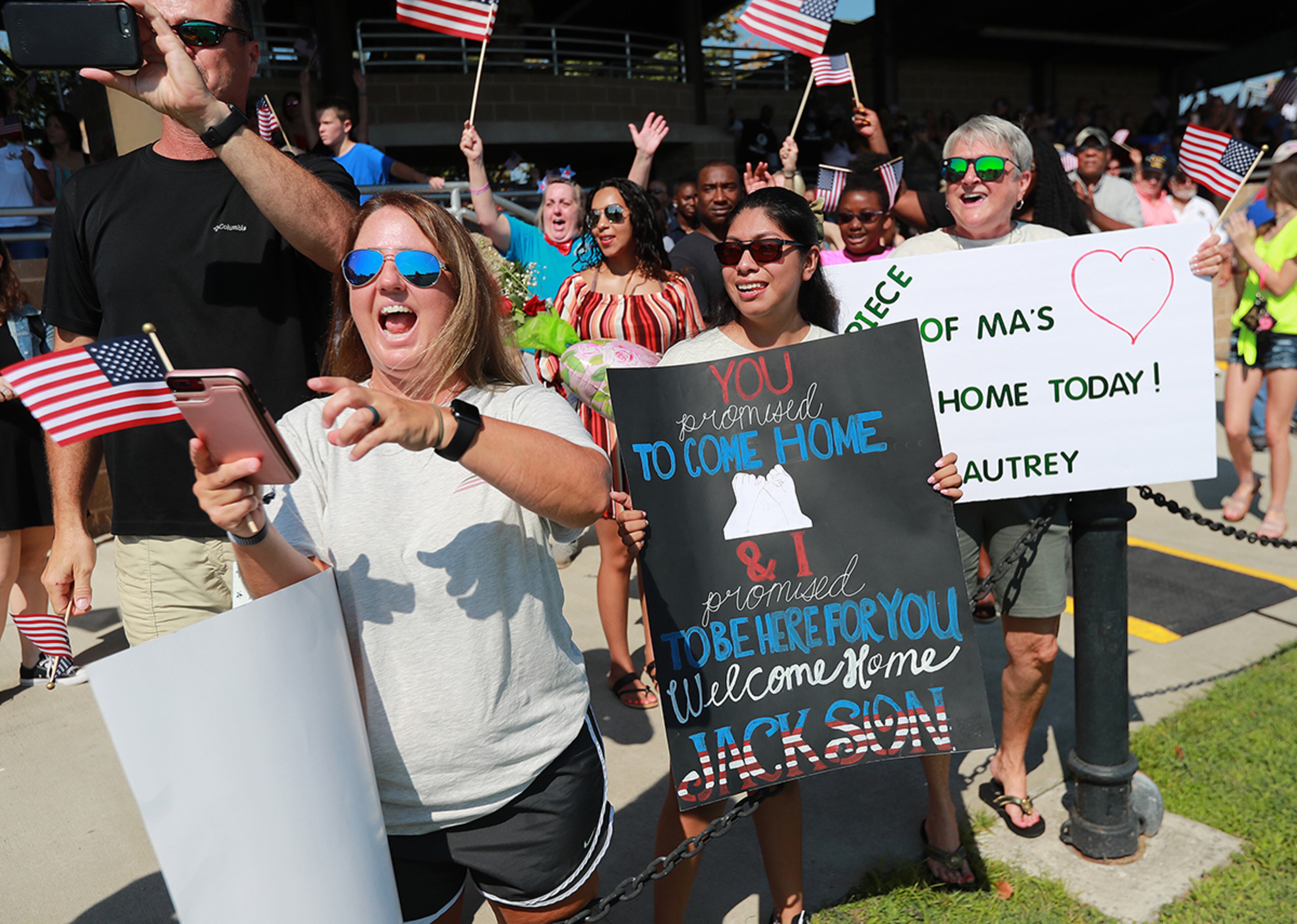 July 30, 2019 Fort Stewart: Julie Autrey (from left), the mother of pfc Jackson Autrey, girlfriend Raquel Godinez, and grandmother Ma Wanda Autrey cheer his arrival when they spot him as soldiers of the 48th Infantry Brigade Combat Team representing units from across the state return home from deployment to Afghanistan in support of Operation Resolute Support at Cottrell Field on Tuesday, July 30, 2019, in Fort Stewart. Curtis Compton/ccompton@ajc.com
