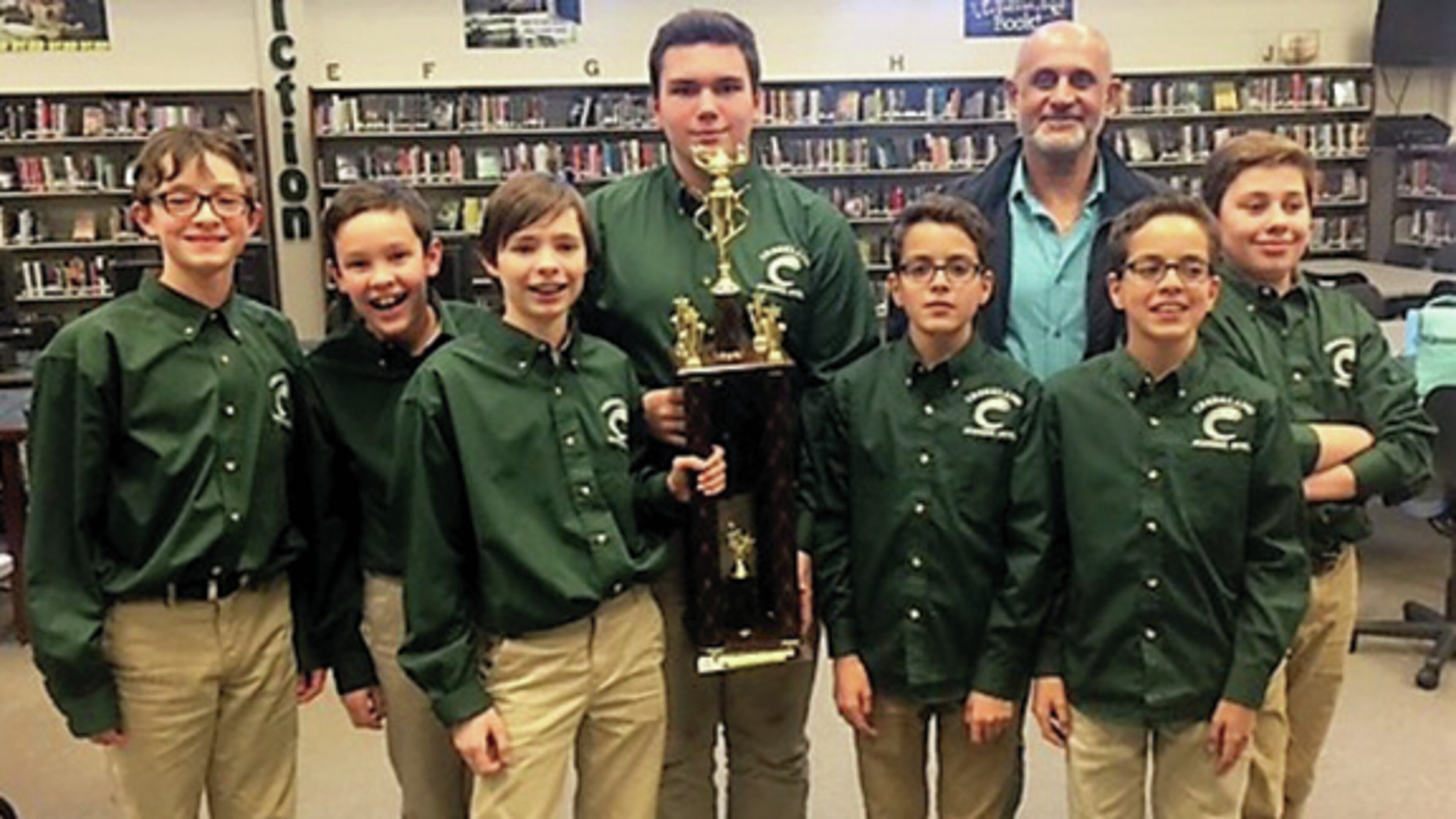 Celebrating their win are, from left, Cal Pace, Justin Bolsen, Sean Yates, Captain Joseph Satterfield, Er’el Moyal, Coach Dr. Mark Nazemzadeh, Jordan Moyal and Hampton Barrineau.