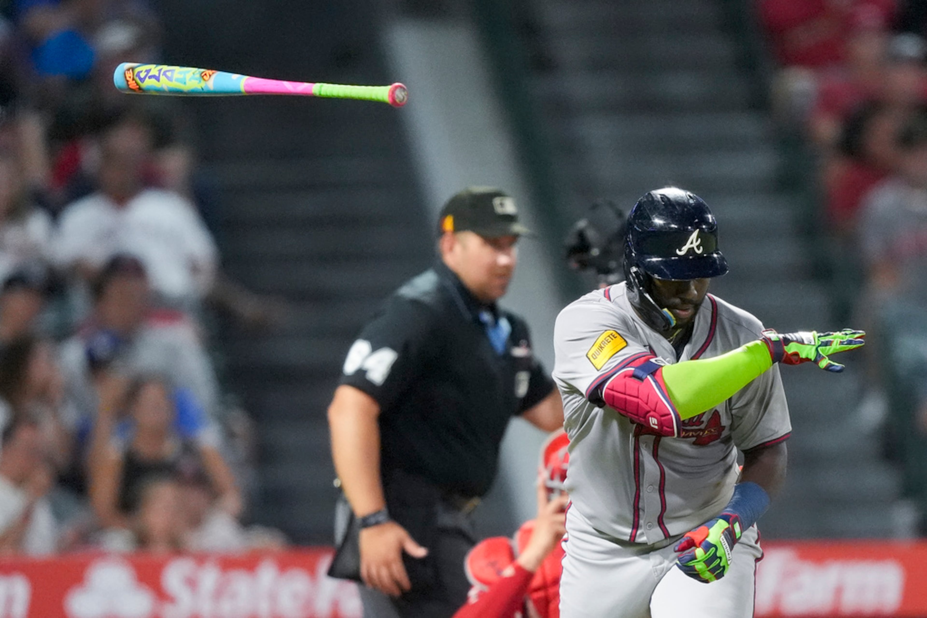 Atlanta Braves' Michael Harris II, right, tosses his bat after hitting a single during the fifth inning of a baseball game against the Los Angeles Angels, Saturday, Aug. 17, 2024, in Anaheim, Calif. The Braves won 11-3. (AP Photo/Ryan Sun)