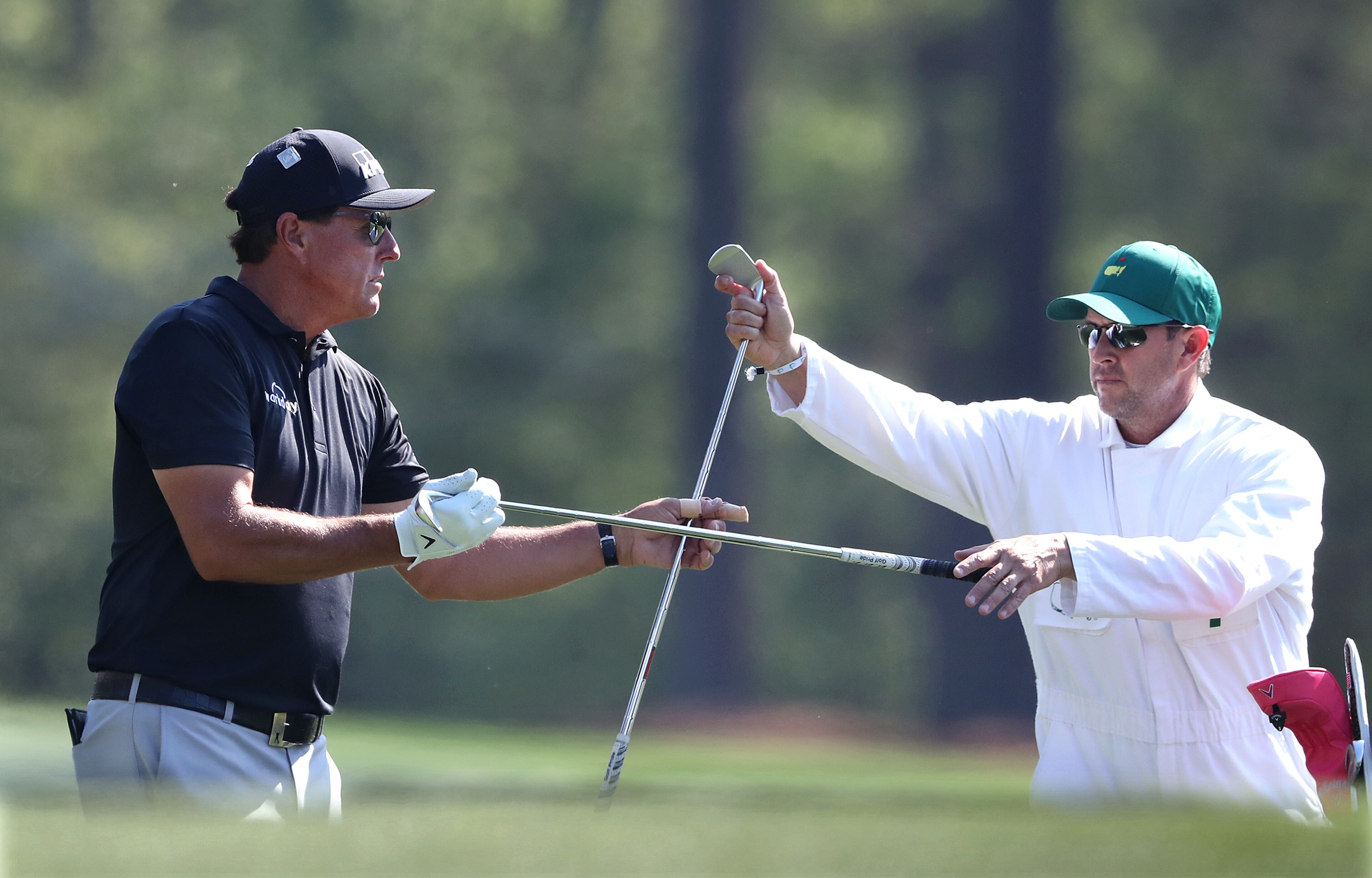 040621 Augusta: Phil Mickelson changes his club selection with his caddy Tim Mickelson on the 12th tee during his practice round for the Masters at Augusta National Golf Club on Tuesday, April 6, 2021, in Augusta. “Curtis Compton / Curtis.Compton@ajc.com”