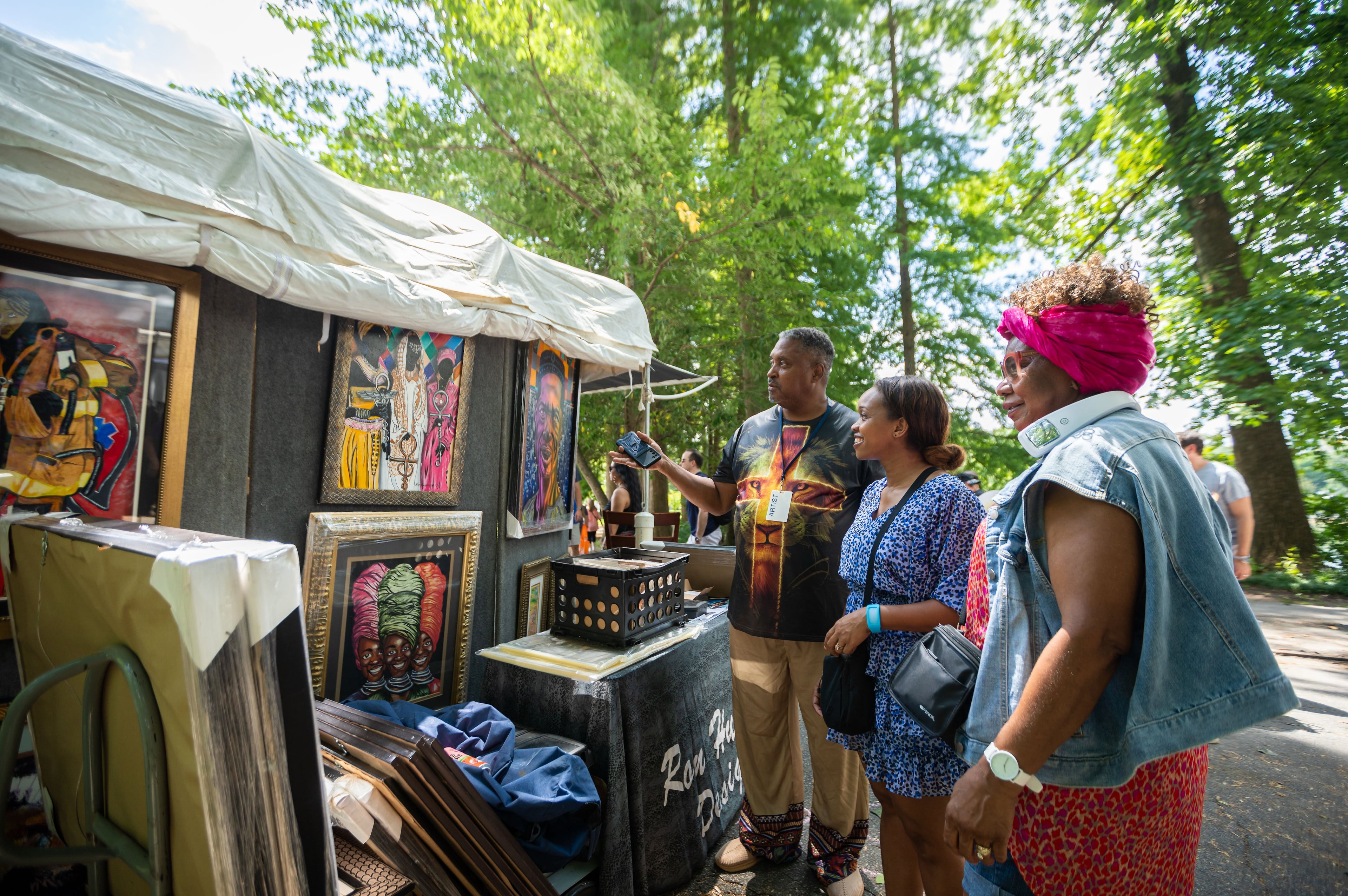 Attendees look at artwork at the Piedmont Park Arts Festival