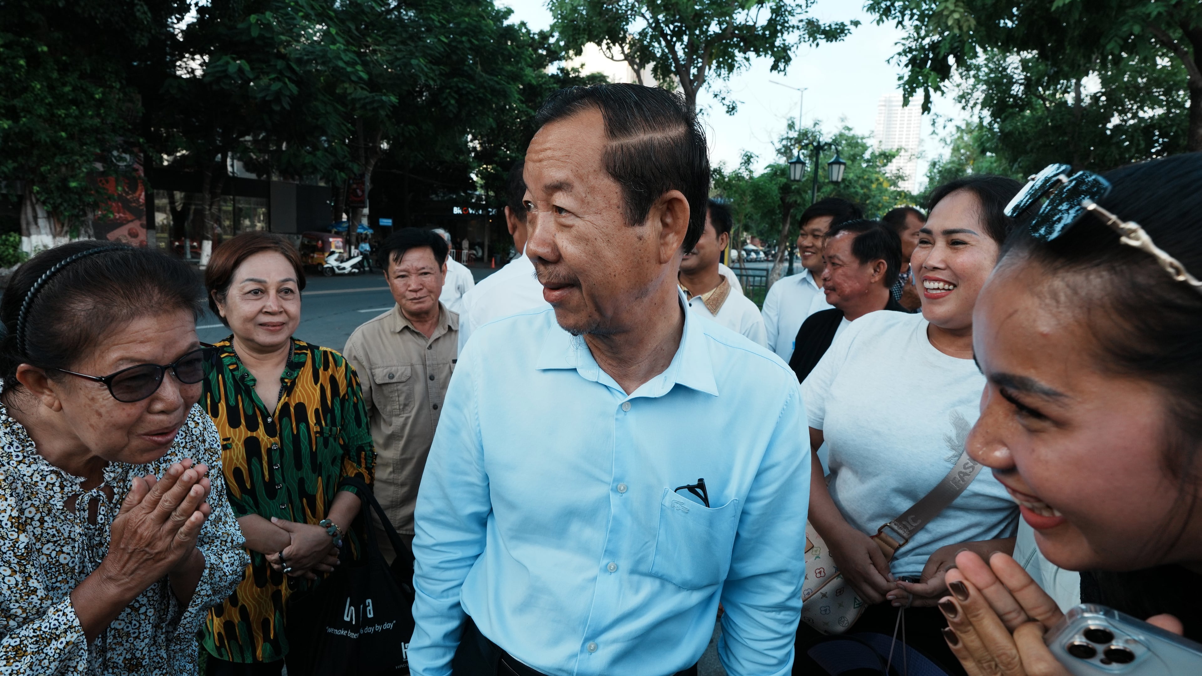 Supporters greet Rong Chhun, a prominent Cambodian opposition politician, center, as he arrives at his hearing at the Supreme Court in Phnom Penh, Cambodia, Monday, June 15, 2026. (AP Photo/Heng Sinith)