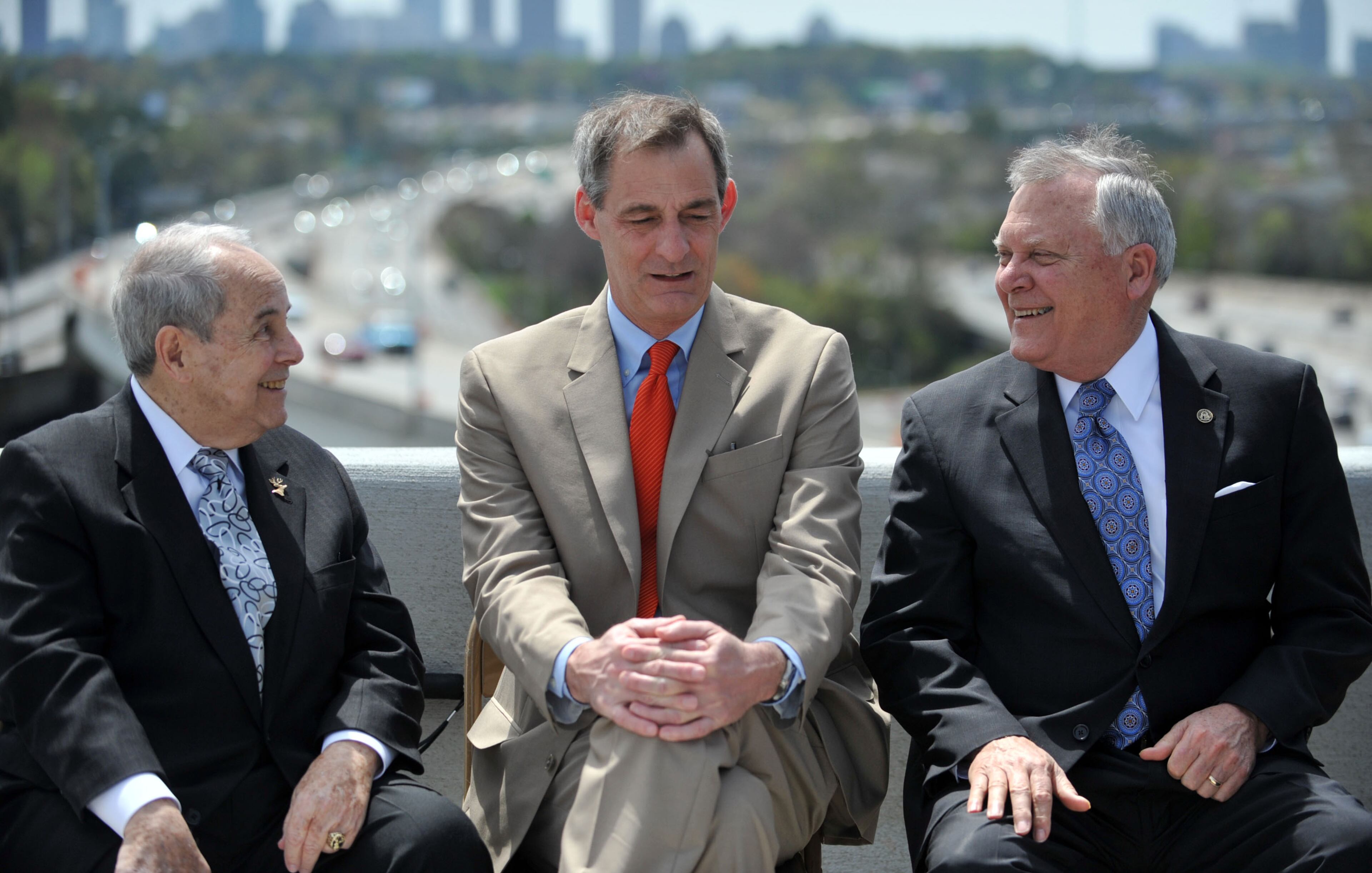 Former Atlanta Mayor Sam Massell (left) talks with Atlanta City Councilman Howard Shook and Governor Deal. Governor Nathan Deal and other state and local leaders conducted a brief ribbon-cutting celebration of the opening of the new flyover ramps Wednesday, April 2, 2014. The ramps provide I-85 southbound traffic with direct access to GA 400 northbound and also give GA 400 southbound motorists a direct ramp to I-85 northbound.