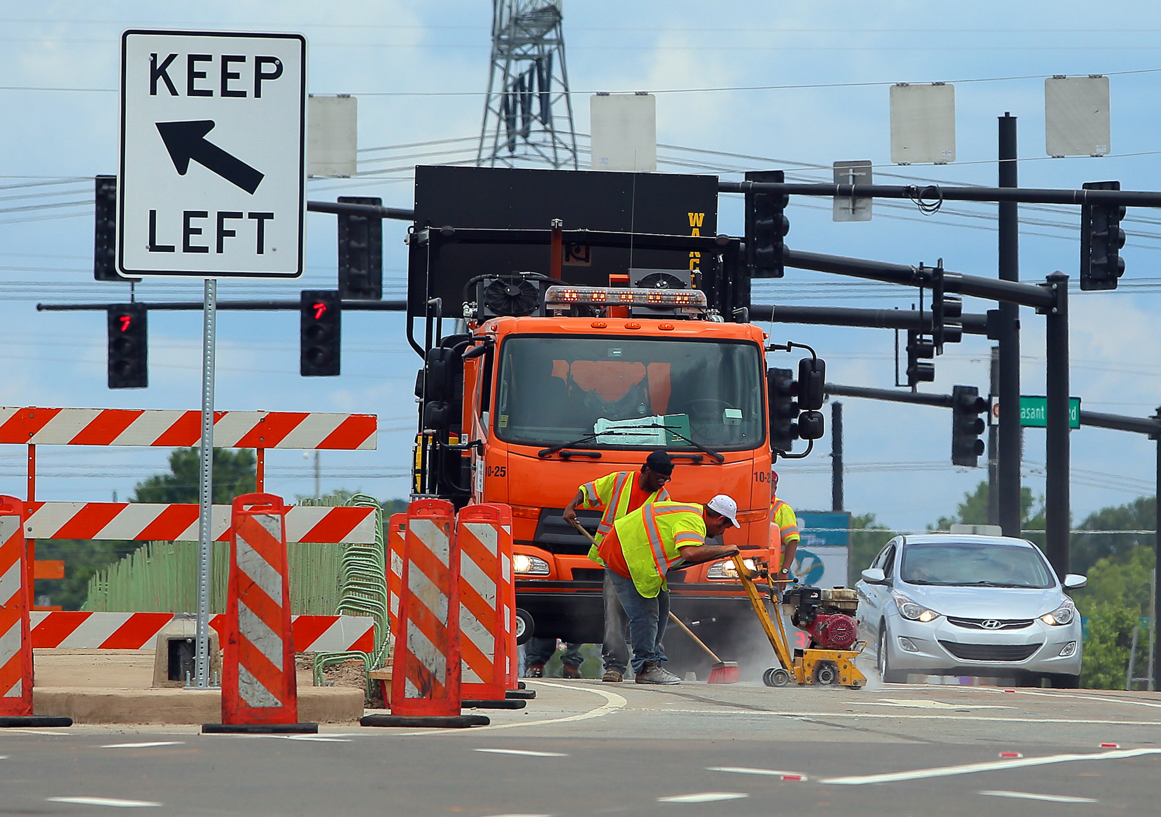 A road crew scrambles to put the finishing touches on the new "diverging diamond" interchange in Gwinnett County.