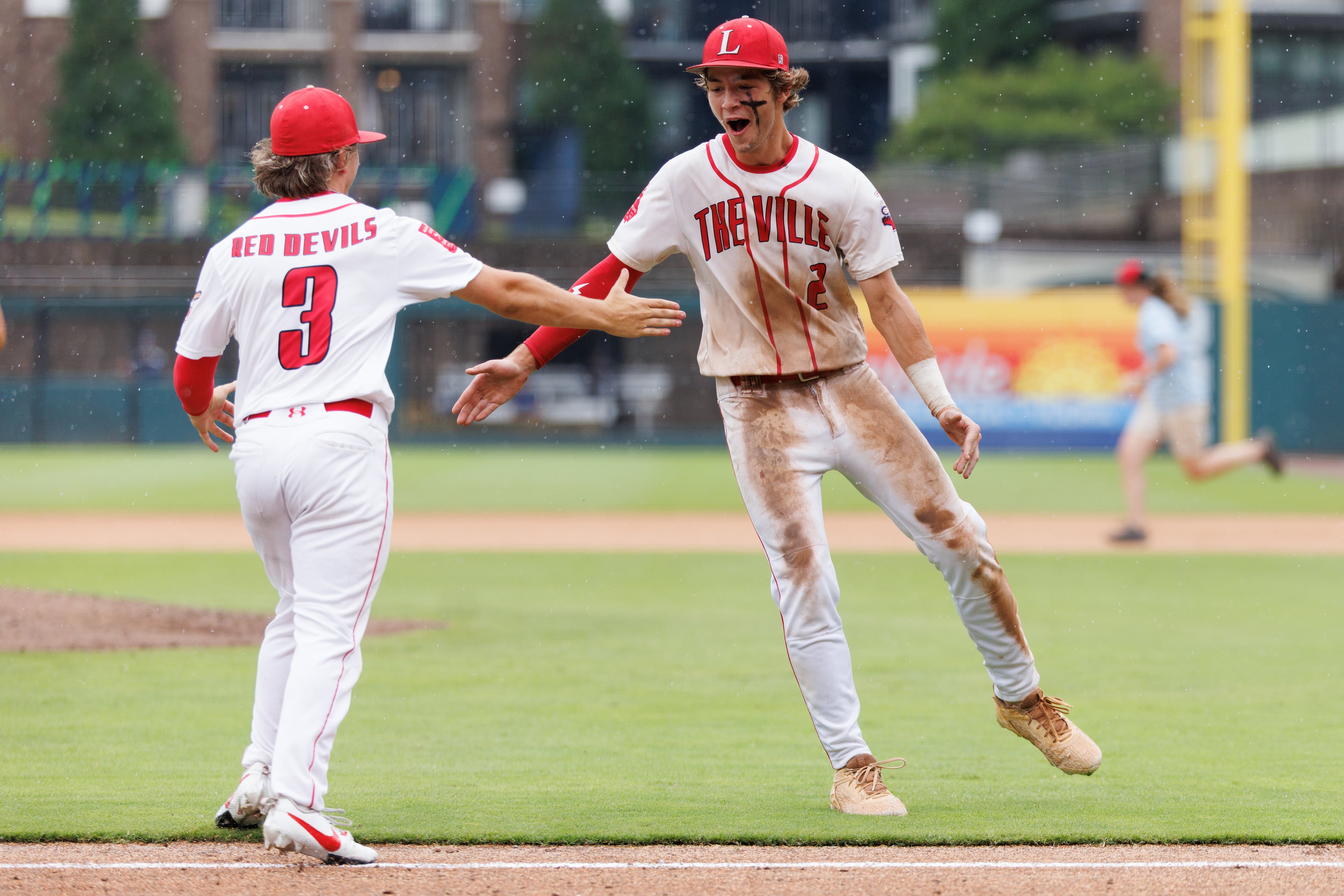 Loganville's Colton Hollis (left) and Brantley Carter celebrate after Loganville beat Pope in Game 1 of the GHSA Class 5A baseball state championship series Monday, May 25, 2026, at Gwinnett Field in Lawrenceville. (Estela Muñoz/AJC)