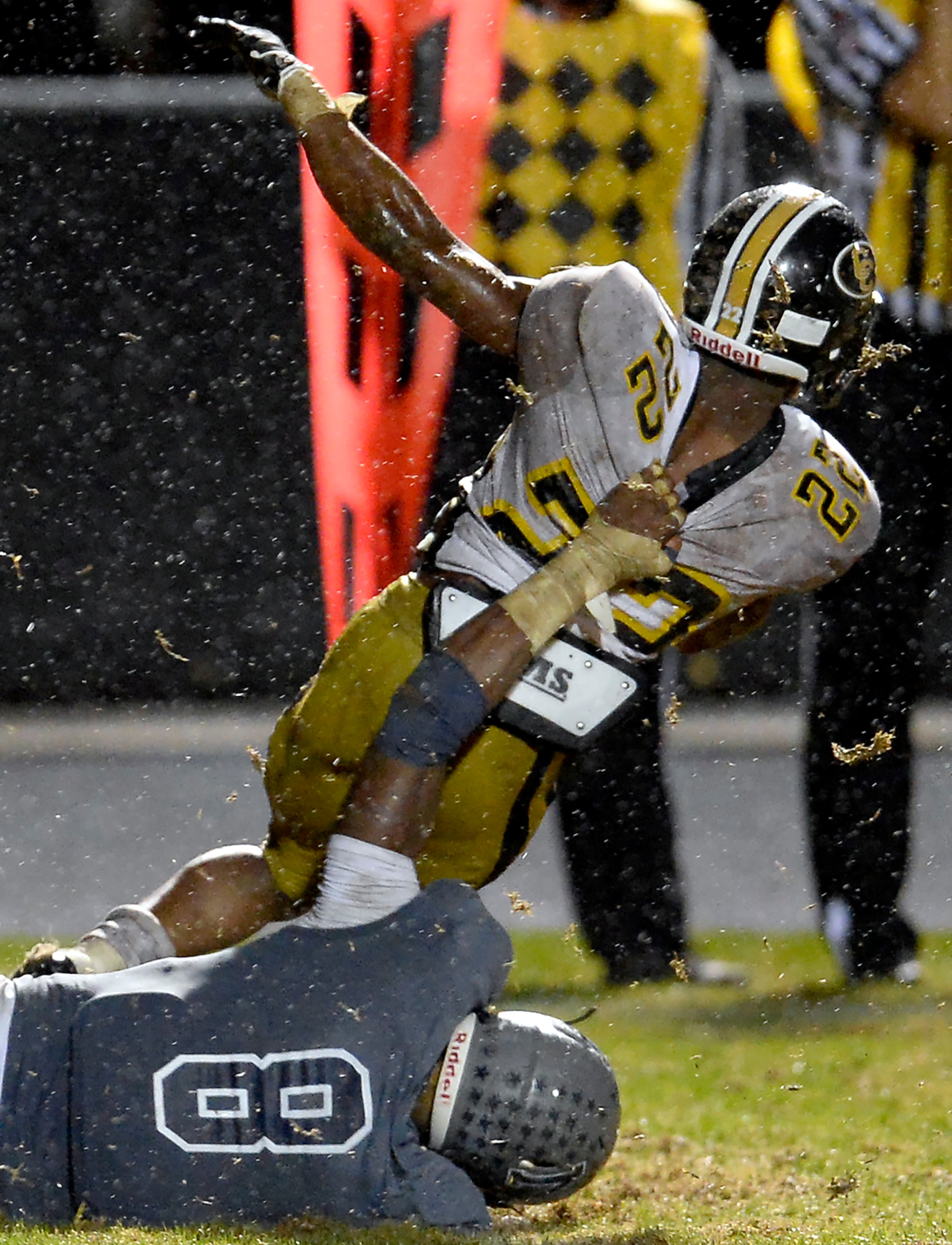 Colquitt County's Sihiem King (22) is grabbed from behind by Norcross defender Lorenzo Carter (8) for a loss in the second half of their AAAAAA semifinal game at Blue Devil Stadium on Friday, Dec. 6, 2013, in Norcross, Ga. Time was called at 10:18 in the fourth quarter due to lightning in the area.