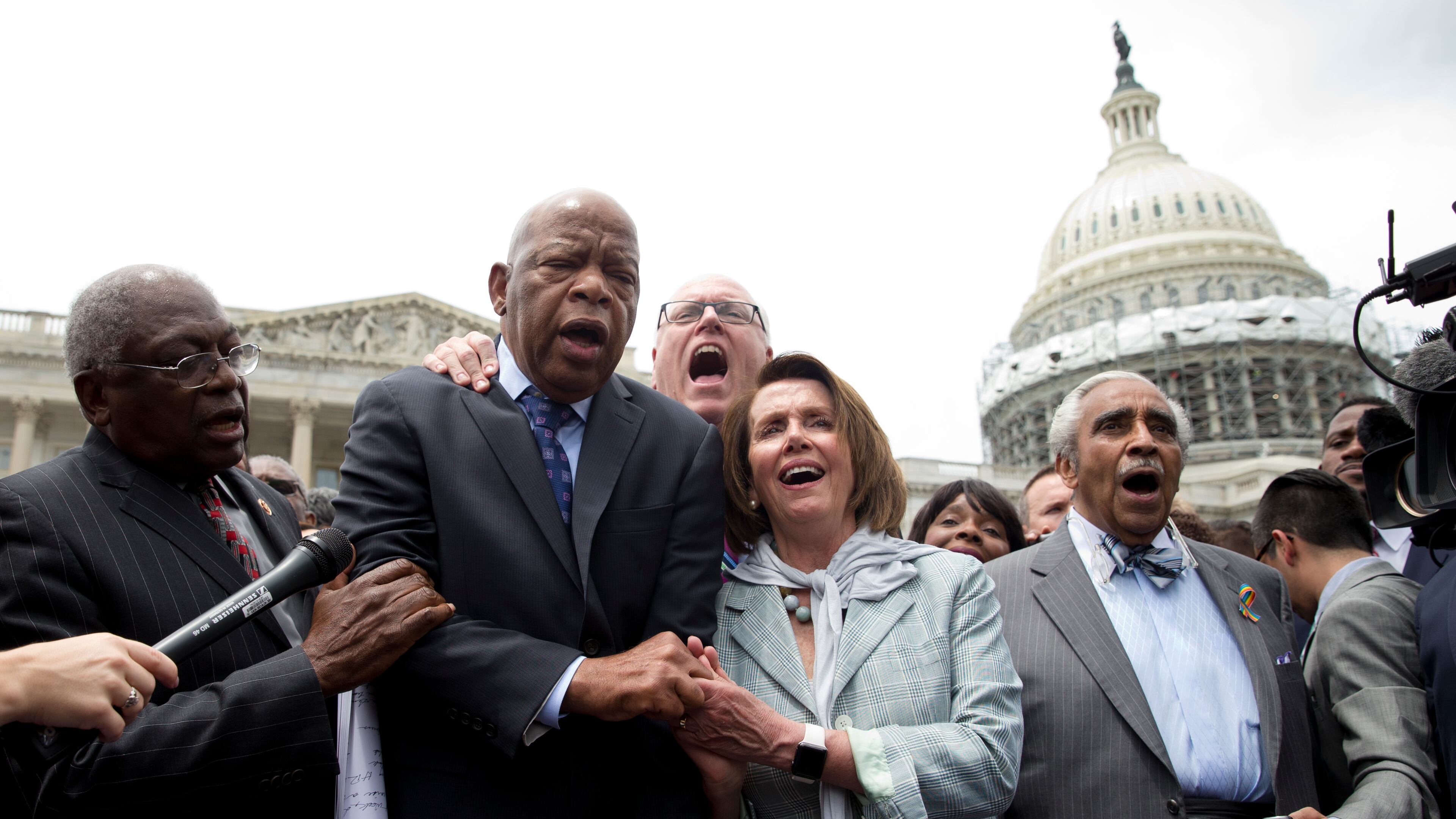 From left, House Assistant Minority Leader James Clyburn of S.C., Rep. John Lewis, D-Ga., Rep. Joseph Crowley, D-N.Y., House Minority Leader Nancy Pelosi of Calif. and Rep. Charles Rangel, D-N.Y., sing "We Shall Overcome" on Capitol Hill in Washington, Thursday, June 23, 2016, after House Democrats ended their sit-in protest. (AP Photo/Carolyn Kaster)