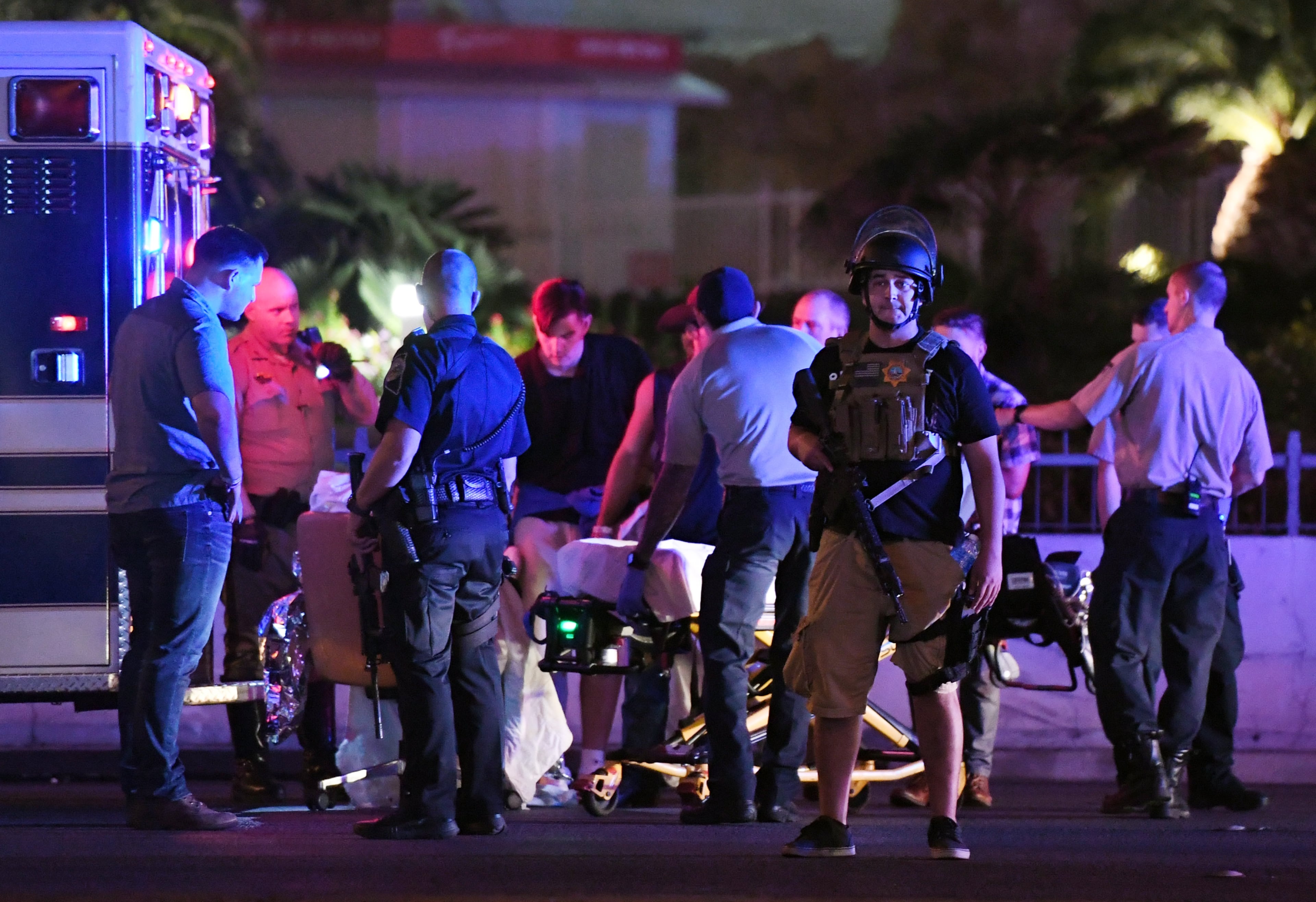 LAS VEGAS, NV - OCTOBER 02: Police officers stand by as medical personnel tend to a person on Tropicana Ave. near Las Vegas Boulevard after a mass shooting at a country music festival nearby on October 2, 2017 in Las Vegas, Nevada .A gunman has opened fire on a music festival in Las Vegas, leaving over 20 people dead. Police have confirmed that one suspect has been shot. The investigation is ongoing. (Photo by Ethan Miller/Getty Images)