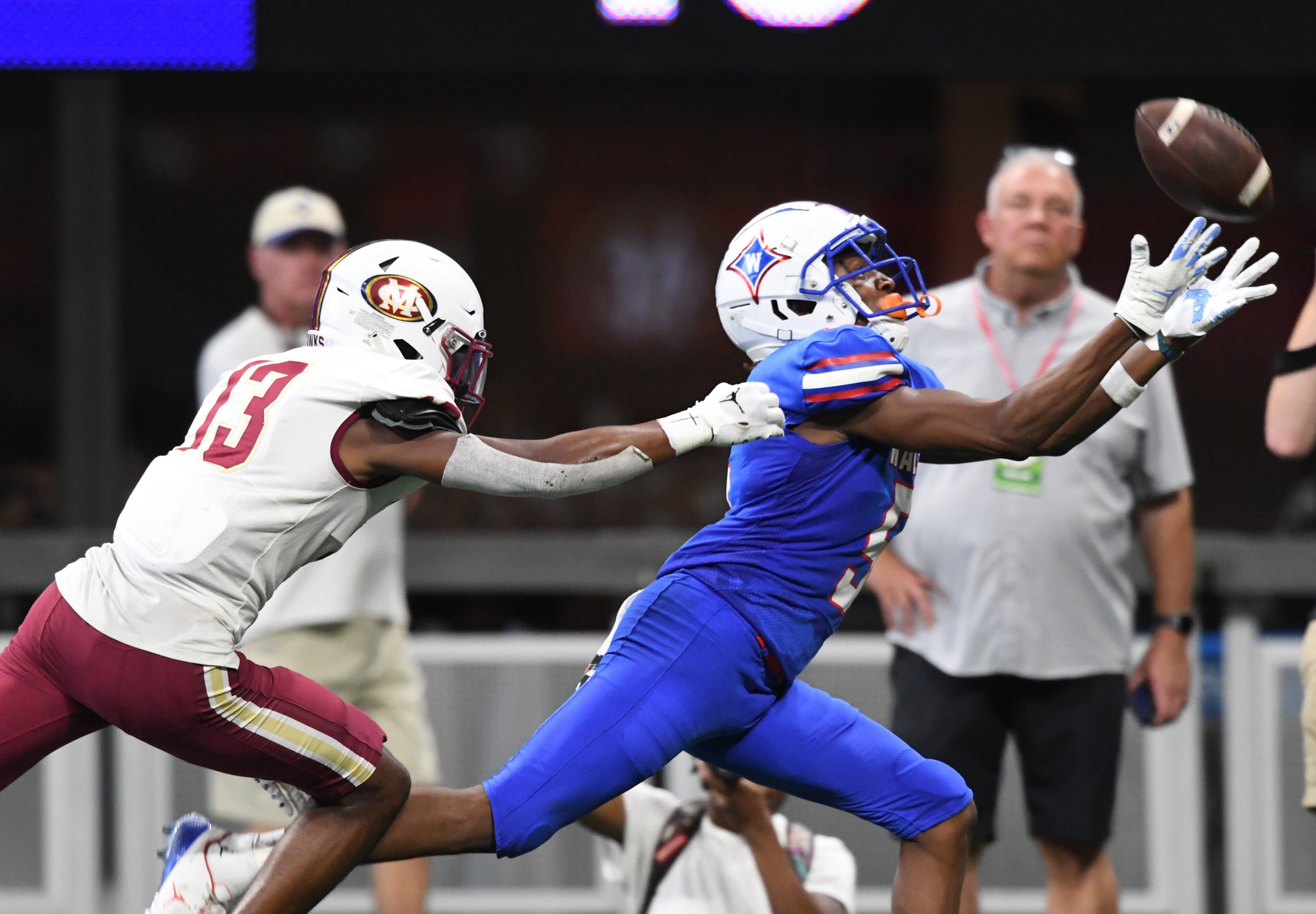 August 20 , 2022 Atlanta - Walton's Ayden Jackson (5) is not able to catch under pressure from Mill Creek's Jaiden Patterson (13) during the 2022 Corky Kell Classic at Mercedes Benz Stadium on Saturday, August 20, 2022. (Hyosub Shin / Hyosub.Shin@ajc.com)