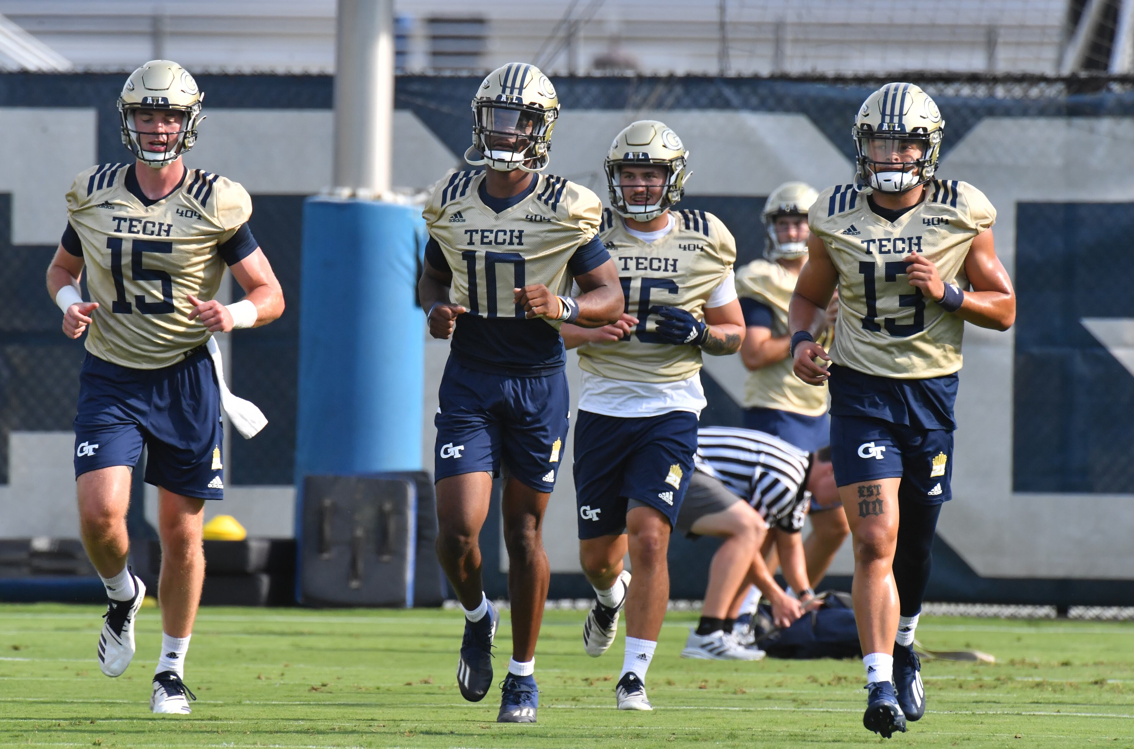 Georgia Tech's quarterbacks (from left) Trad Beatty (15), Jeff Sims (10), Chayden Peery (16) and Jordan Yates (13) run on the football field during a football practice at Rose Bowl Field on Georgia Tech Campus in Atlanta on Friday, August 6, 2021. (Hyosub Shin / Hyosub.Shin@ajc.com)