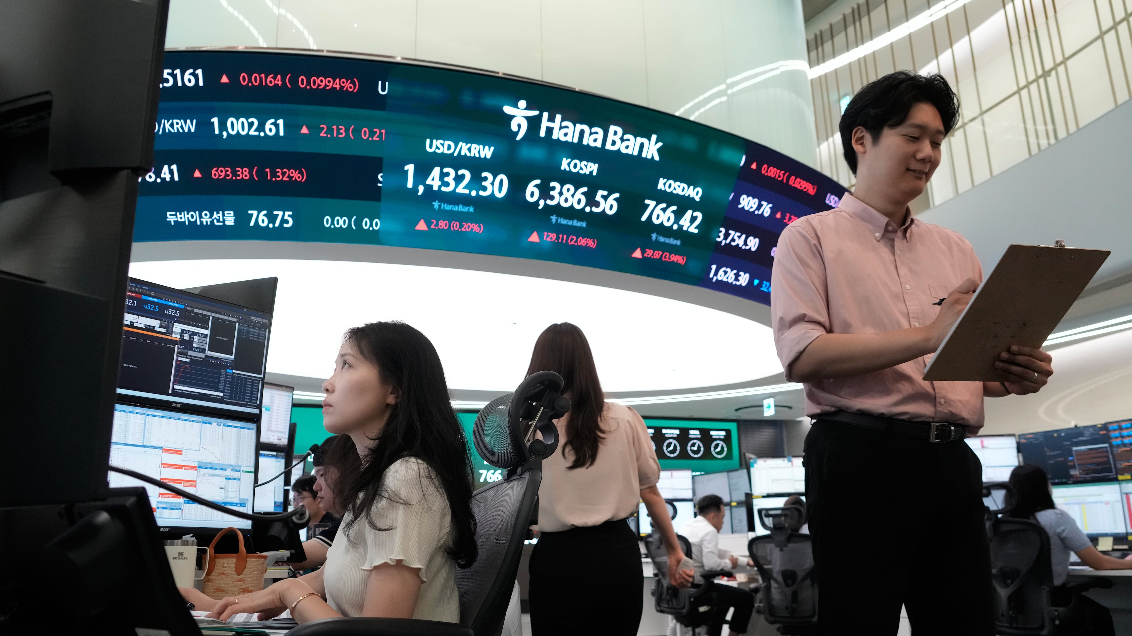 Currency traders work at the foreign exchange dealing room of the Hana Bank headquarters in Seoul, South Korea, Tuesday, Aug. 4, 2026. (AP Photo/Ahn Young-joon)