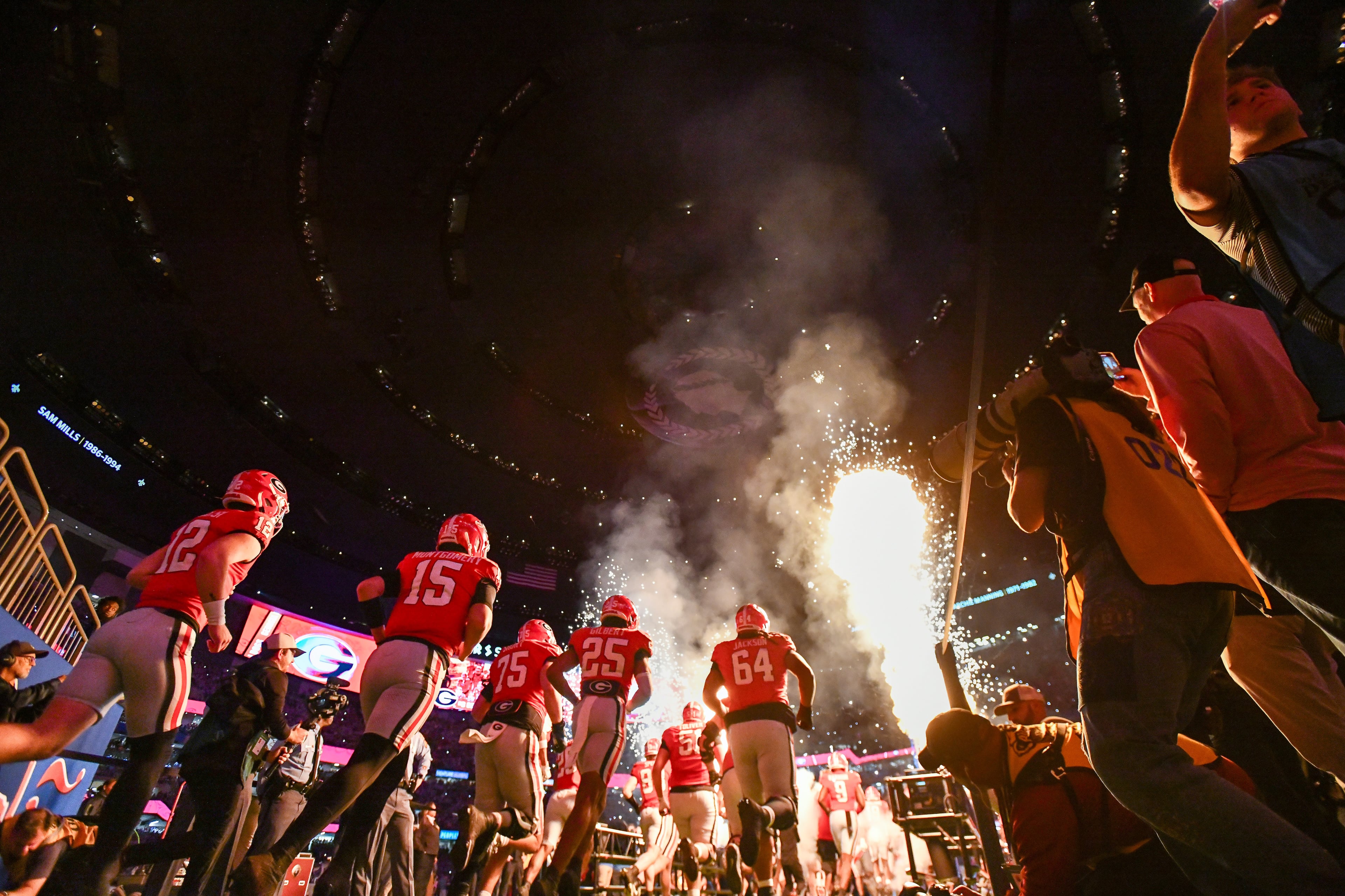 The Georgia Bulldogs team enters the field amid pyrotechnics for the Ole Miss NCAA College Football Playoff quarterfinal game at the Sugar Bowl in the Caesars Superdome, Thursday, Jan. 1, 2026, in New Orleans. (Hyosub Shin/AJC)