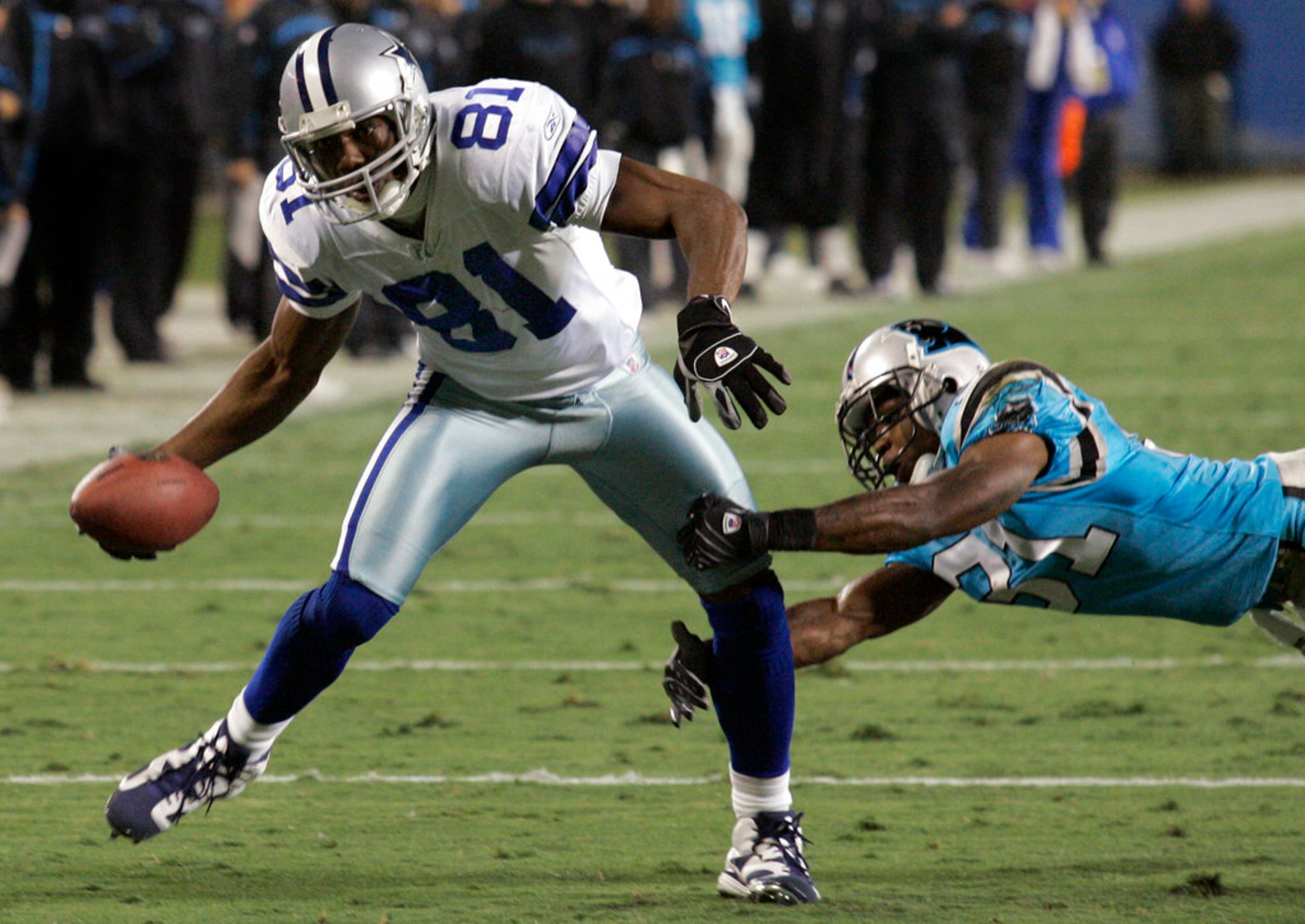 FILE - In this Dec. 22, 2007, file photo, Dallas Cowboys' Terrell Owens (81) pulls away from Carolina Panthers' Richard Marshall (31) as Owens runs for a touchdown after a reception during the first quarter of an NFL football game in Charlotte, N.C. Owens, Randy Moss and Isaac Bruce, among others, are on the ballot in voting Saturday, Feb. 3, for the Pro Football Hall of Fame. (AP Photo/Chuck Burton, File)