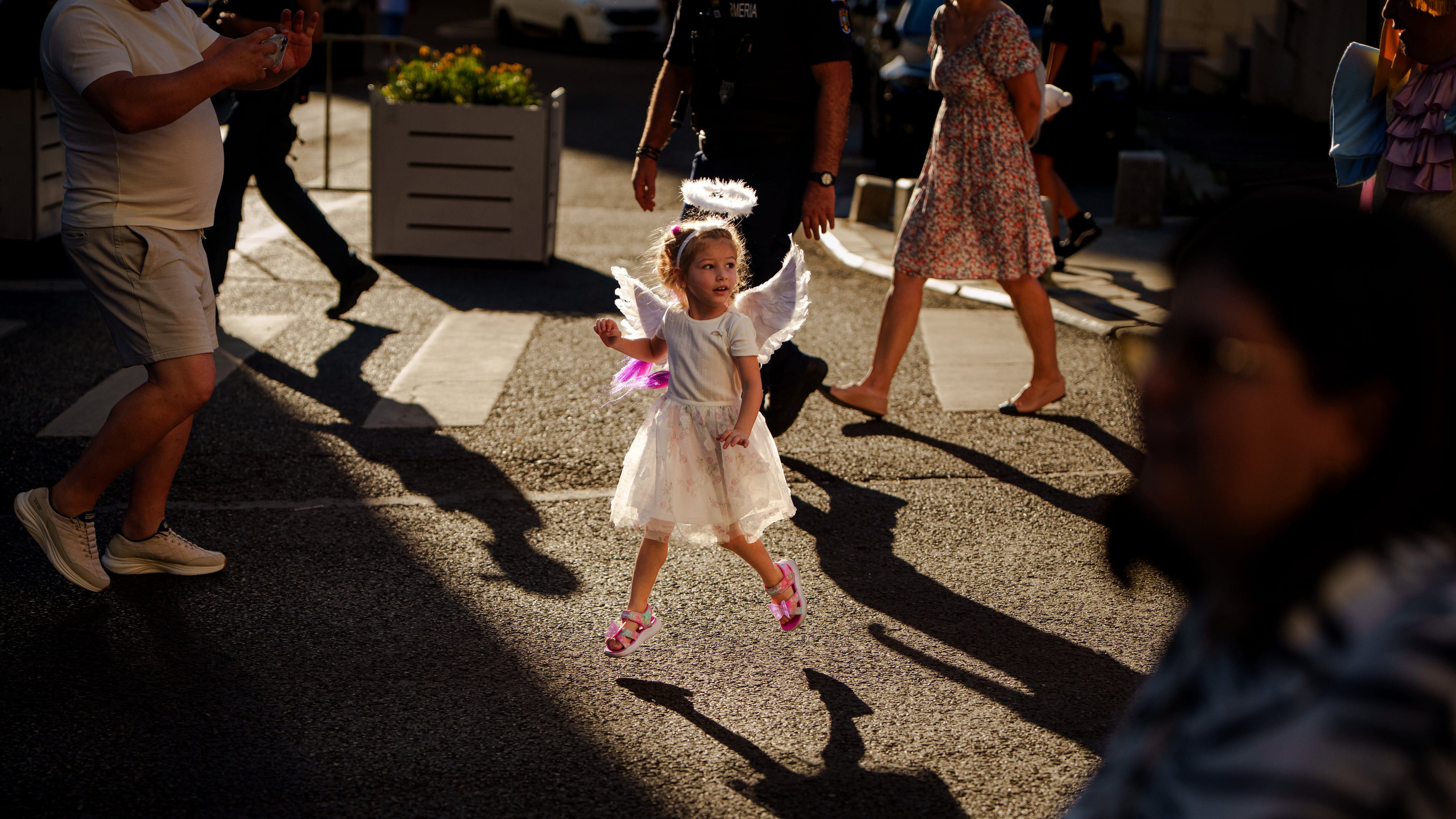A child dressed as an angel runs during an event dubbed the Little Angels' Parade, a Christian-themed street performance featuring dozens of children wearing angel costumes, in Bucharest, Romania, Saturday, Sept. 5, 2026. (AP Photo/ Vadim Ghirda)