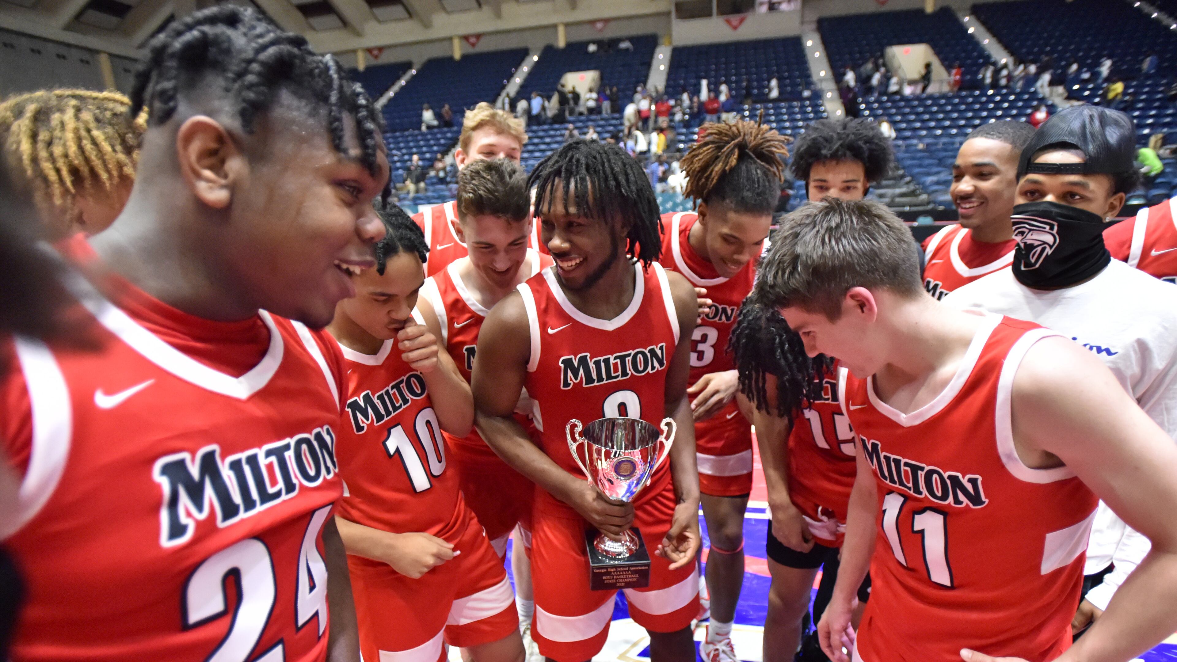 March 13, 2021 Macon - Milton's Bruce Thornton (2) holding the Championship trophy celebrates their victory over Berkmar during the 2021 GHSA State Basketball Class AAAAAAA Boys Championship game at the Macon Centreplex in Macon on Saturday, March 13, 2021 Milton won 52-47 over Berkmar. (Hyosub Shin / Hyosub.Shin@ajc.com)