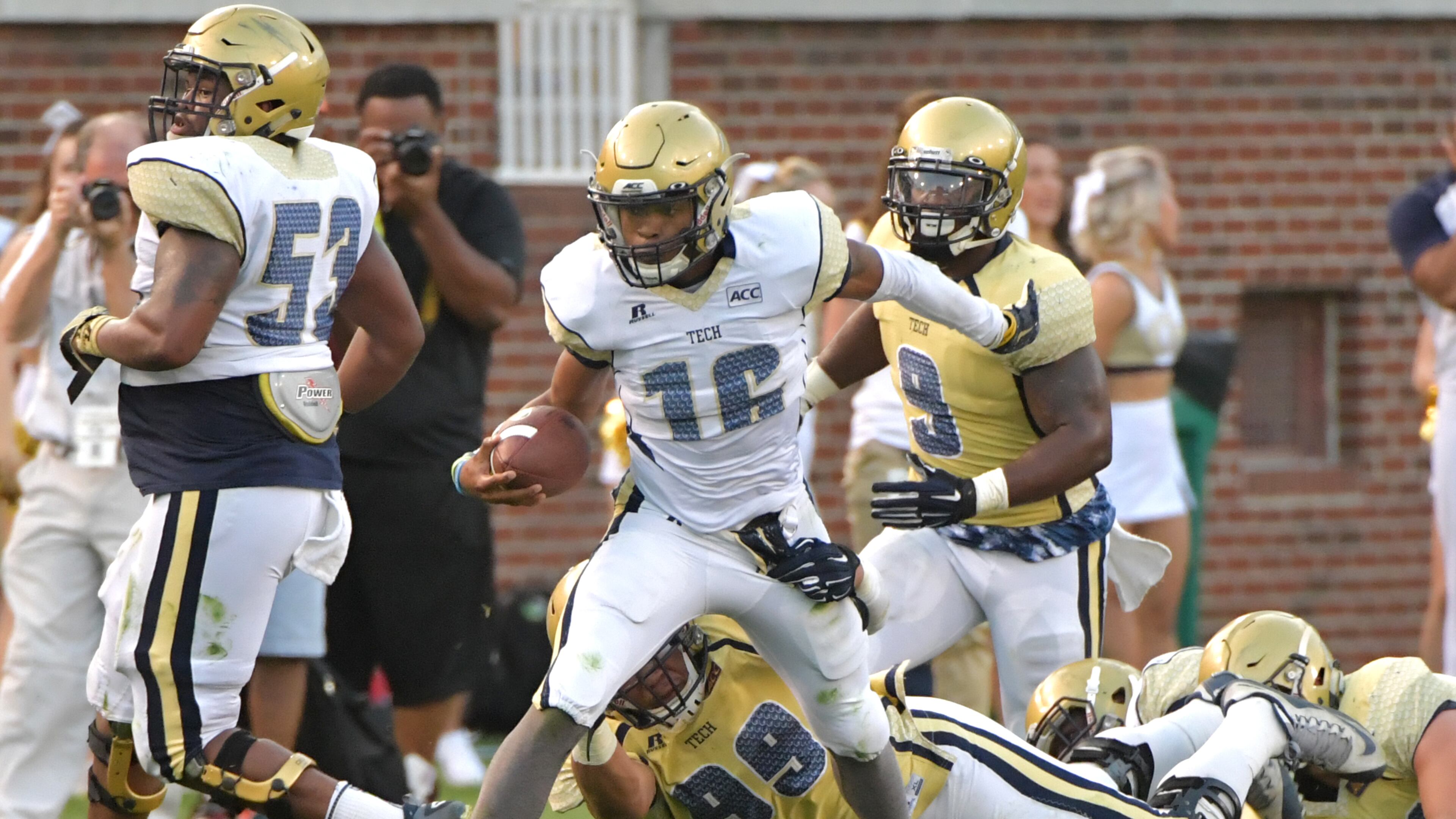 Georgia Tech white-team quarterback TaQuon Marshall (16) runs past gold-team defensive lineman Desmond Branch (99) during the Georgia Tech spring game at Bobby Dodd Stadium on Friday, April 21, 2017. HYOSUB SHIN / HSHIN@AJC.COM