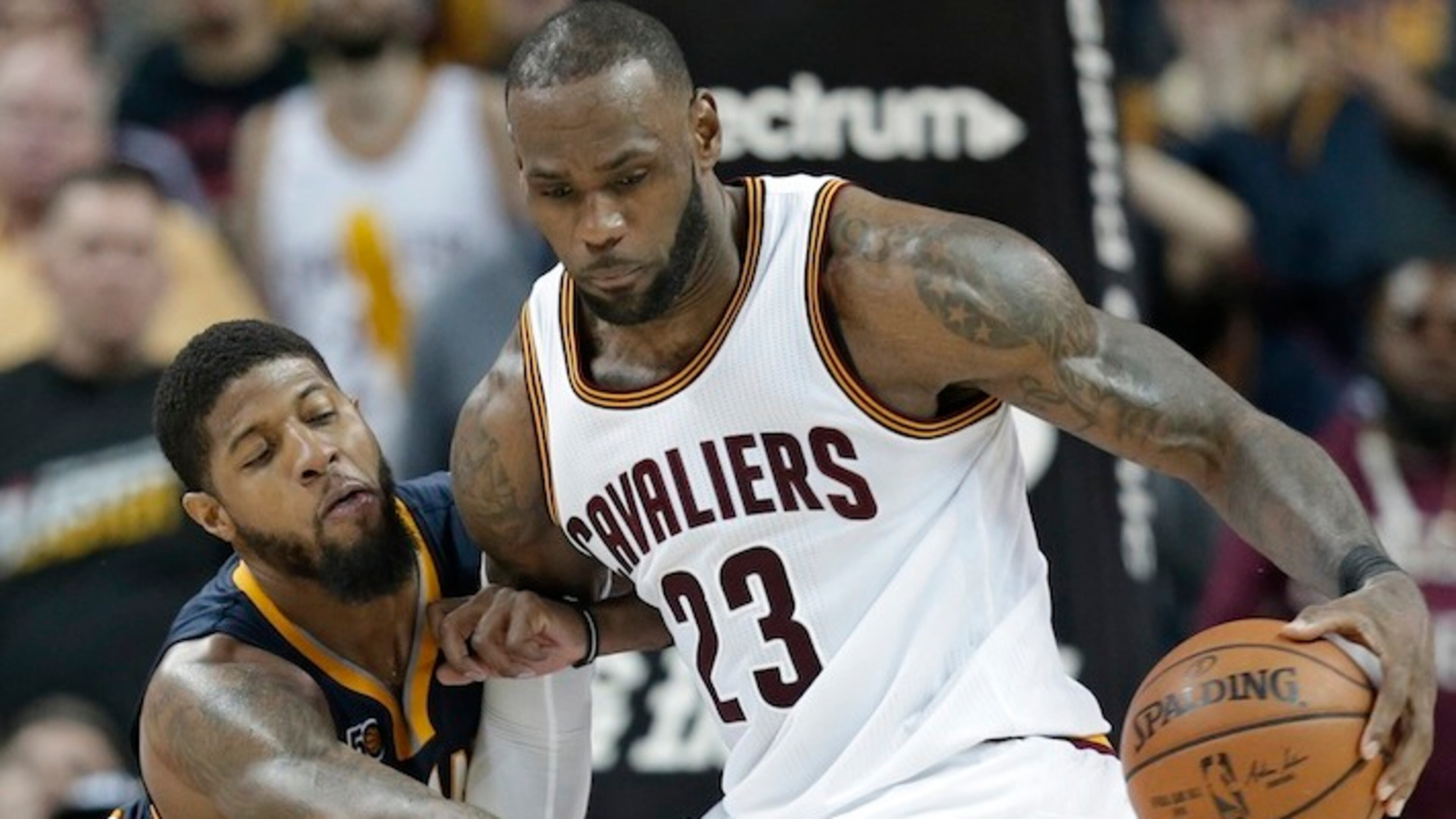 Indiana Pacers' Paul George, left, reaches for the ball as Cleveland Cavaliers' LeBron James drives to the basket in overtime during an NBA basketball game, Sunday, April 2, 2017, in Cleveland. The Cavaliers won 135-130 in double overtime. (AP Photo/Tony Dejak)