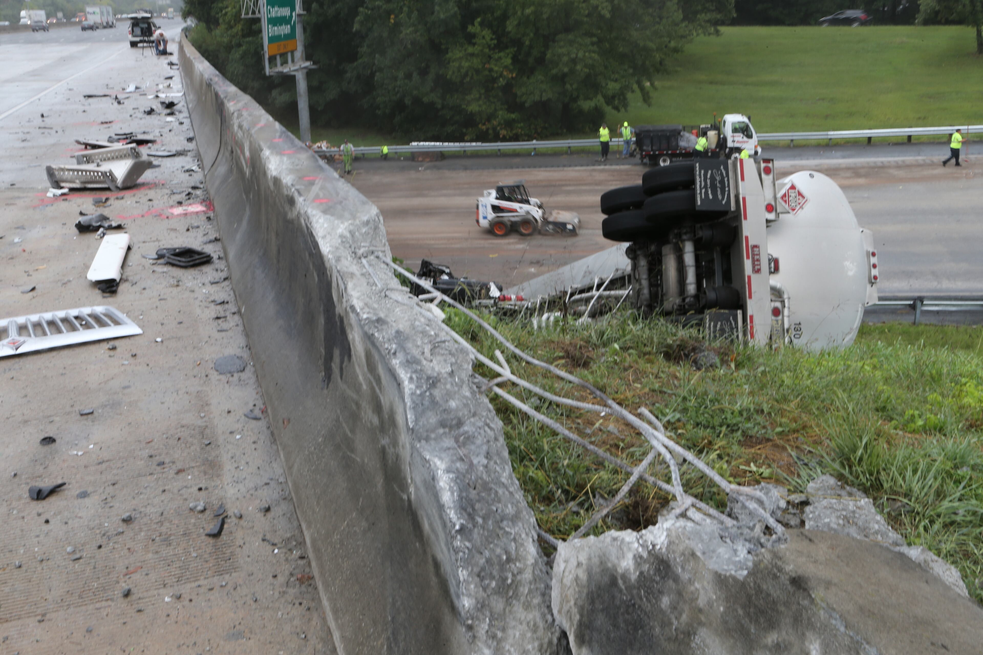One of the busiest interchanges in the state began to re-open in time for the Friday afternoon rush hour. But delays were still heavy more than three hours after two tractor-trailers plunged from I-285 and landed on Ga. 400.