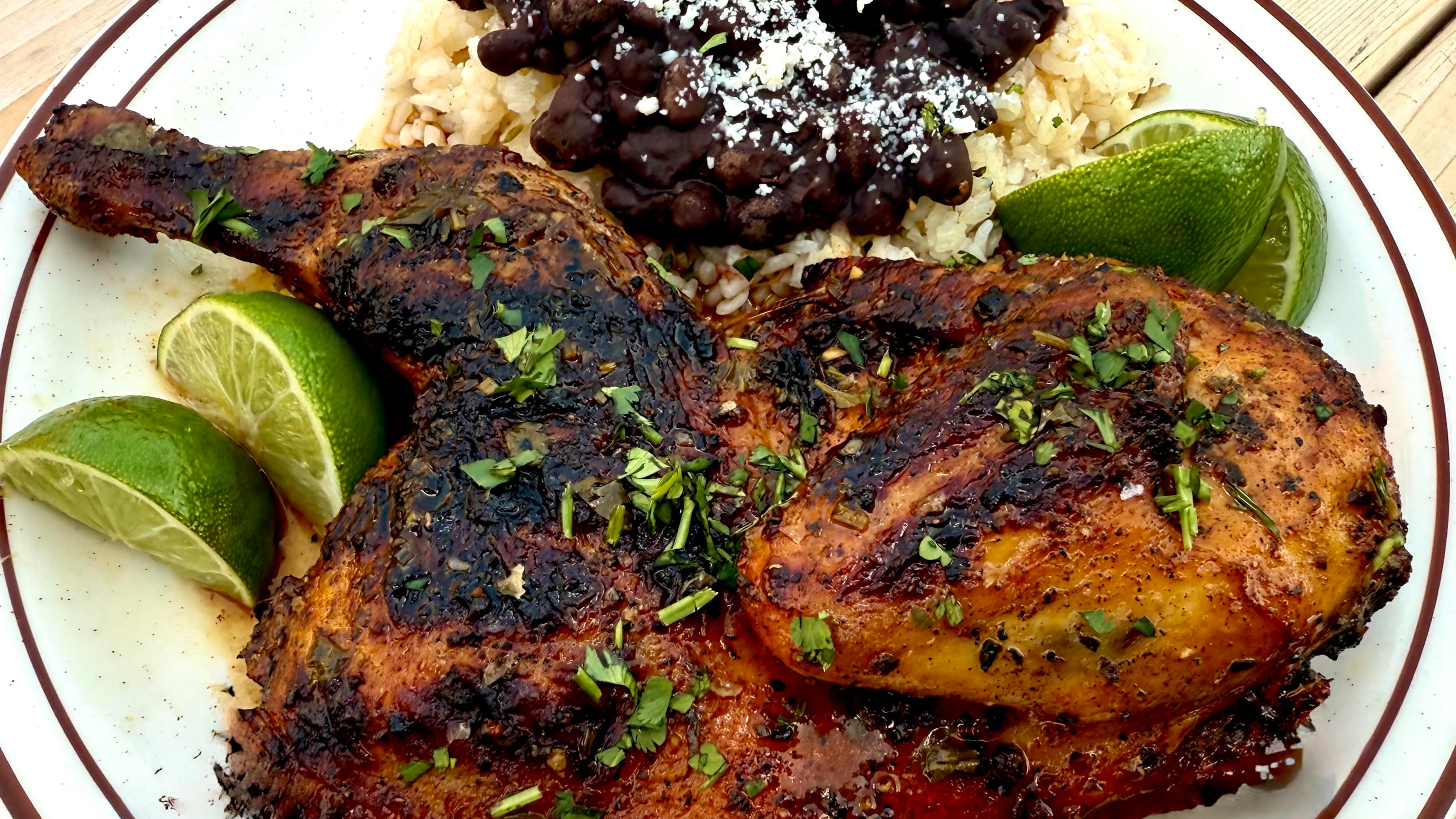 Wyld Bird’s Miami chicken dish includes a grilled chicken half, beans and rice. (Courtesy of Brad Syfan)