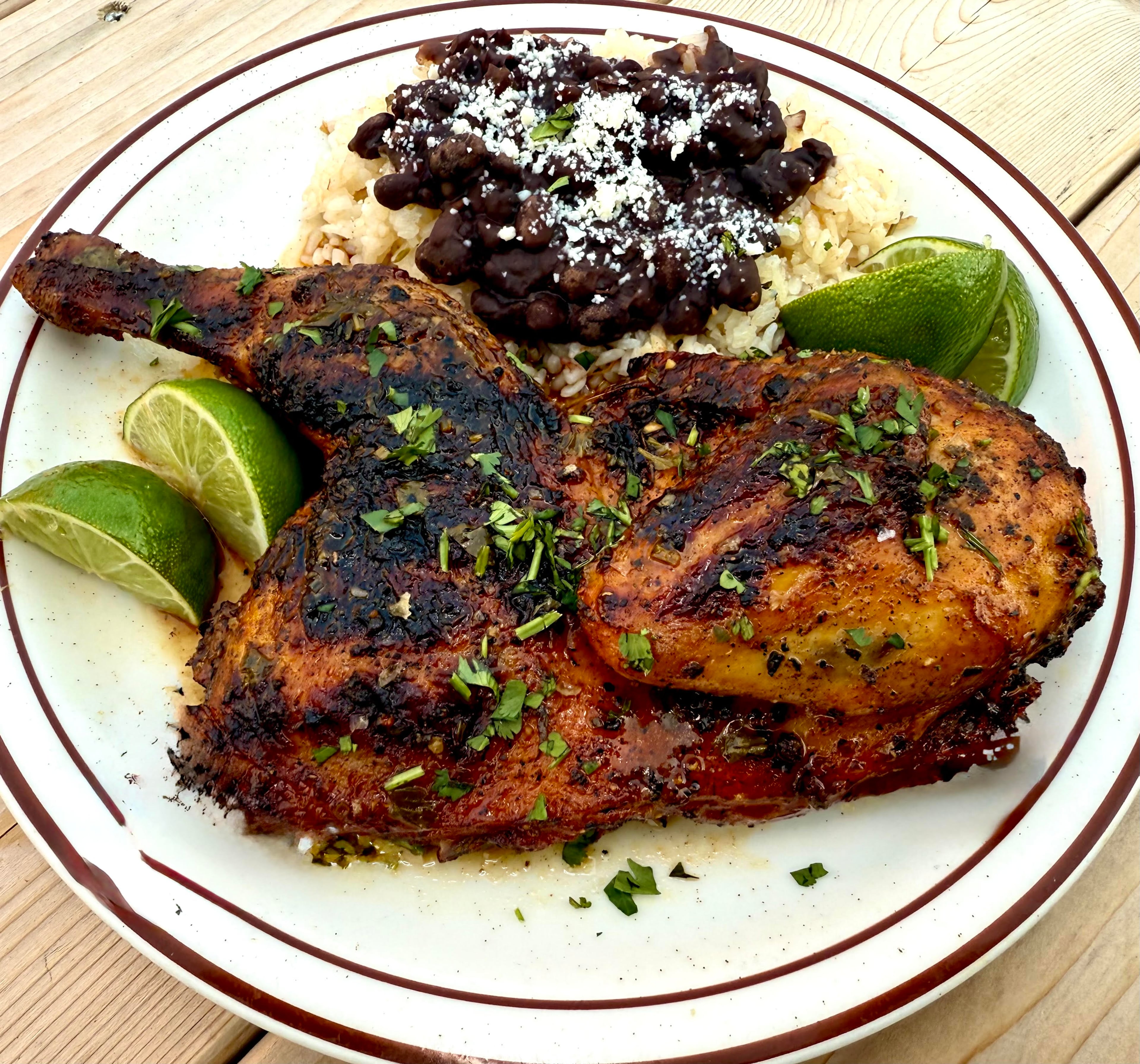 Wyld Bird’s Miami chicken dish includes a grilled chicken half, beans and rice. (Courtesy of Brad Syfan)