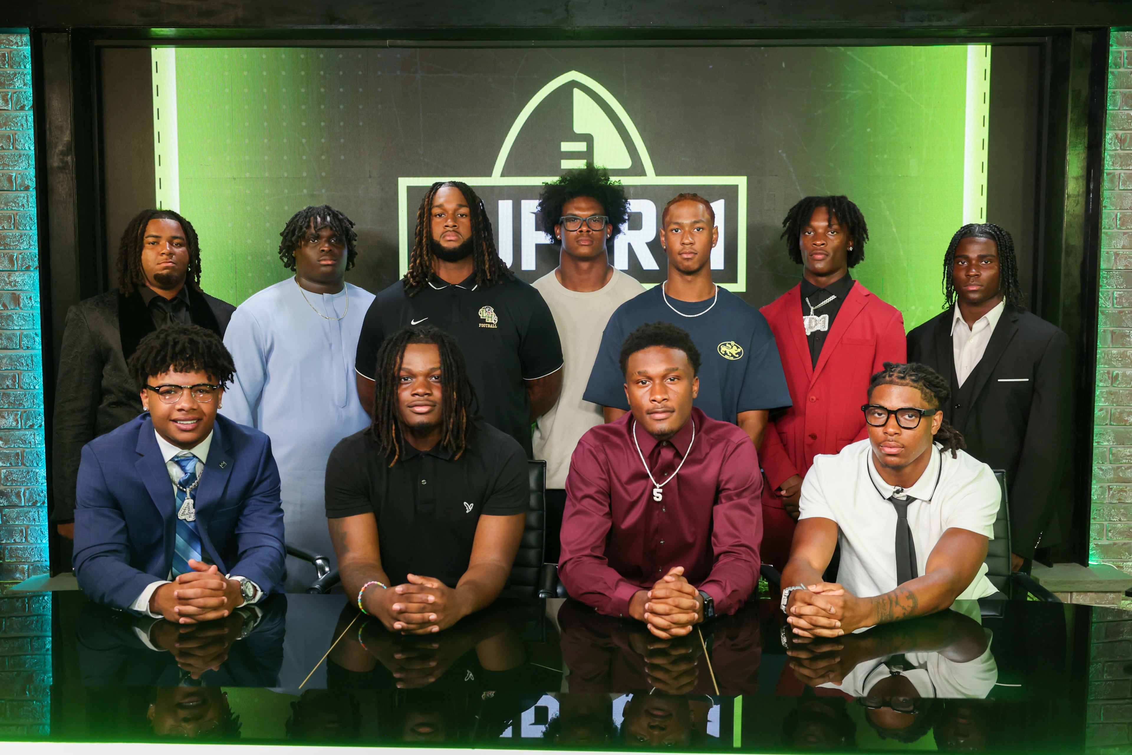 The Super 11 Class of 2026 pose for a portrait at the Super 11 reveal show at Score ATL in Roswell on Aug. 3, 2026. (Arvin Temkar/AJC)