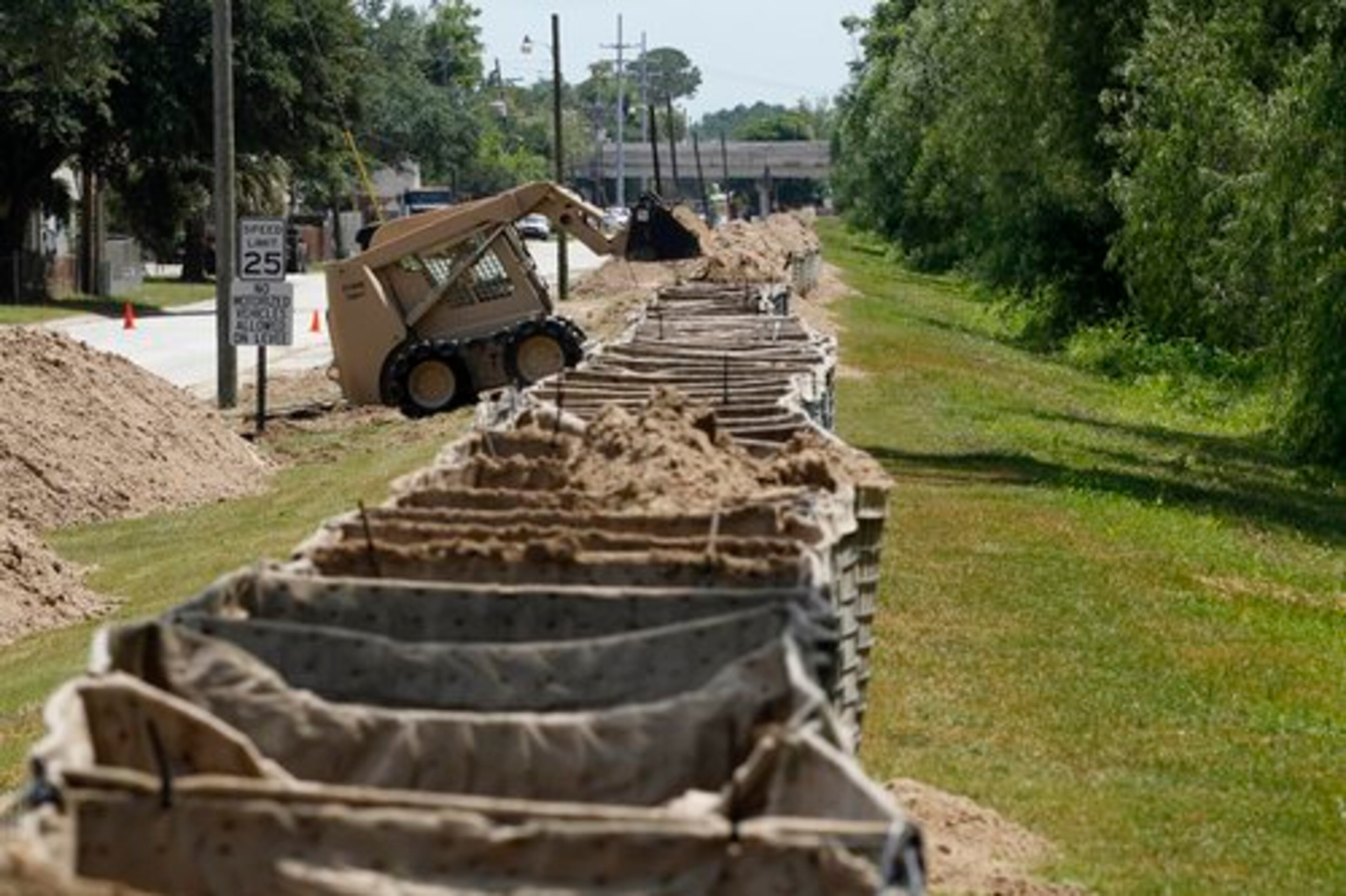 Louisiana National Guardsmen use machinery to fill Hesco baskets with sand to protect residential neighborhoods Tuesday in preparation of impending flooding from the likely diversion of Mississippi River floodwaters into the Atchafalaya Basin, in Morgan City, La.