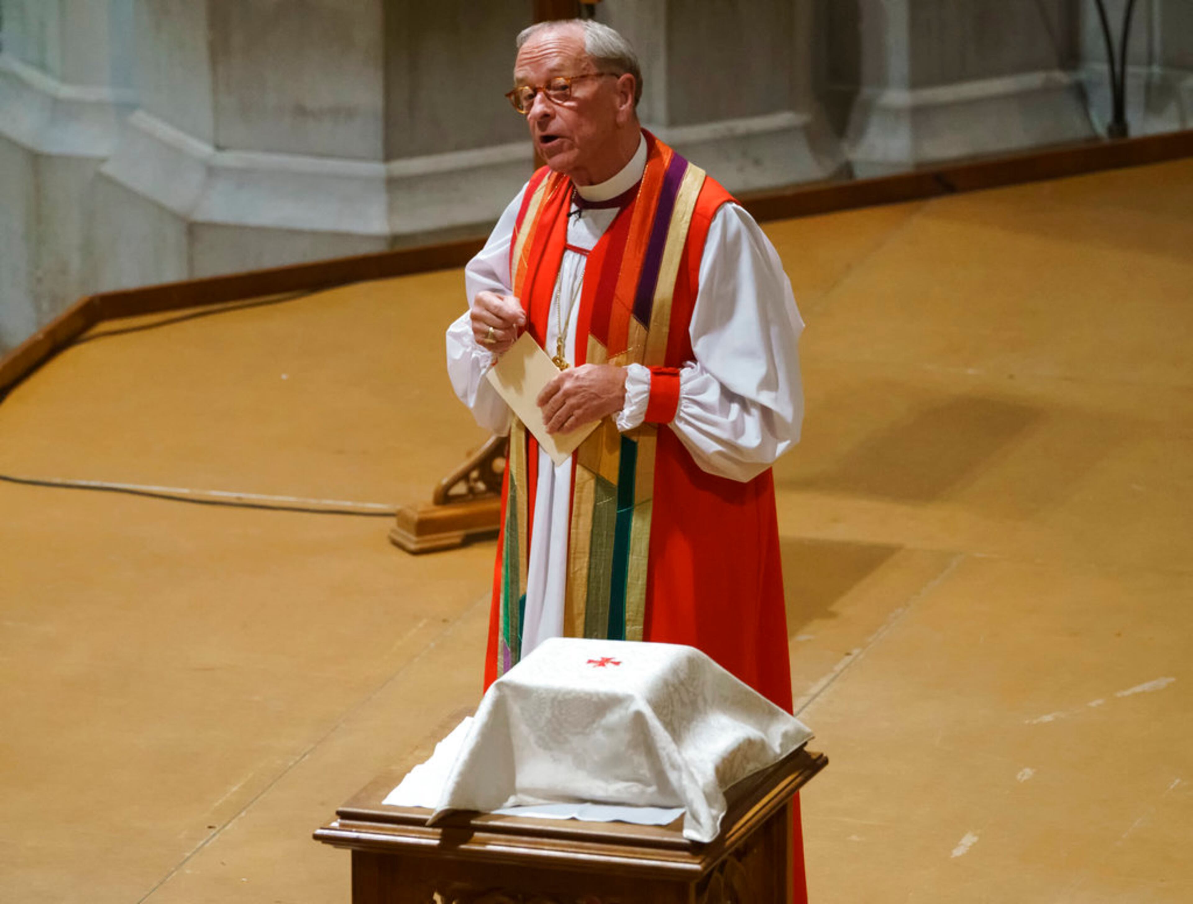 Rev. Gene Robinson looks at the ashes of Matthew Shepard as he delivers the homily at the "Thanksgiving and Remembrance of Matthew Shepard" service at Washington National Cathedral in 2018. The ashes of Shepard, whose brutal murder in the 1990s became a rallying cry for the gay rights movement, were laid to rest in Washington National Cathedral. (Carolyn Kaster/AP)