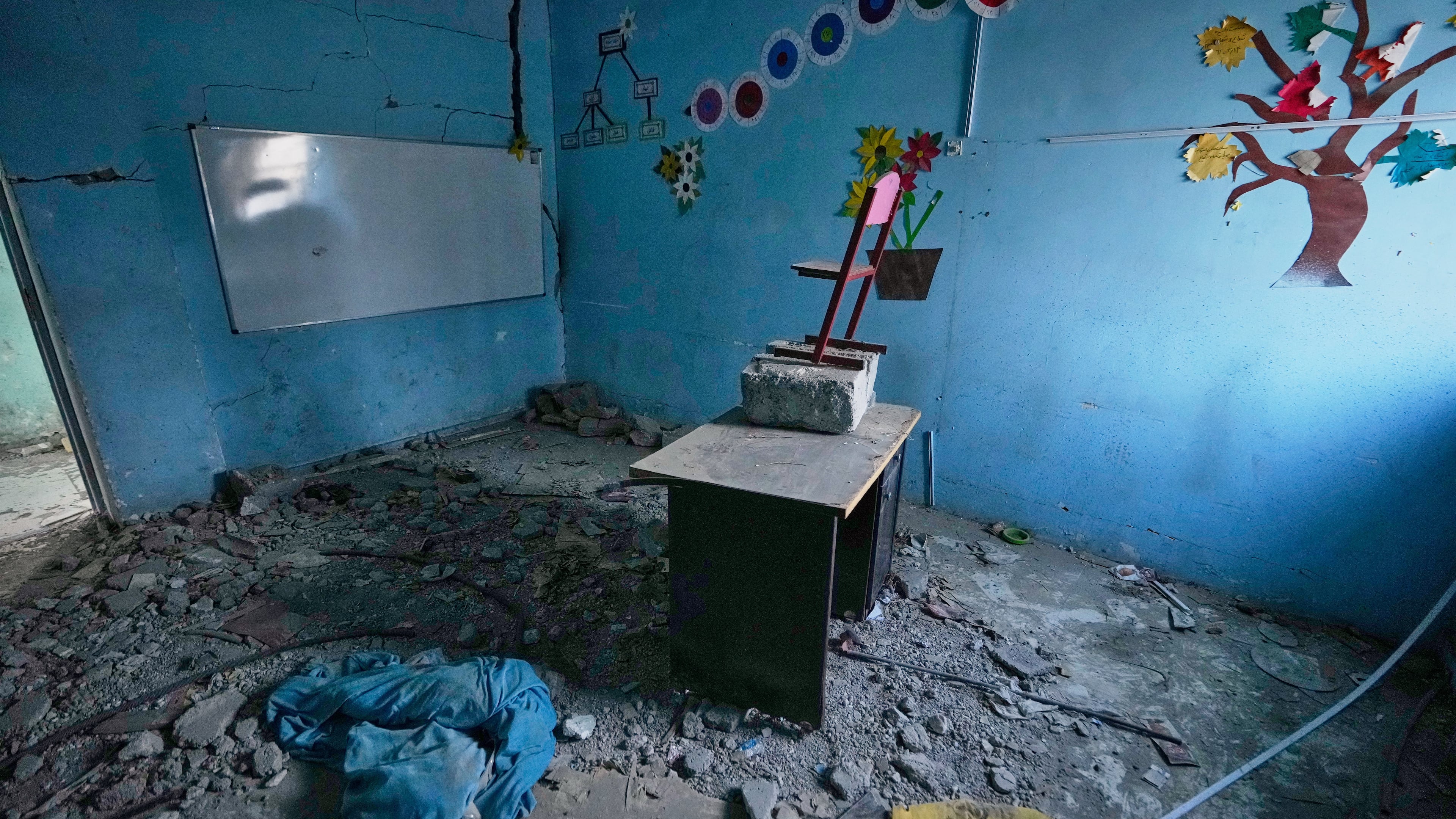 Colorful tree and flower decorations remain on the walls of a rubble-strewn classroom at Shajareh Tayyebeh school, damaged in a U.S. airstrike on Feb. 28, in Minab, southern Iran, Monday, Sept. 7, 2026. (AP Photo/Vahid Salemi)