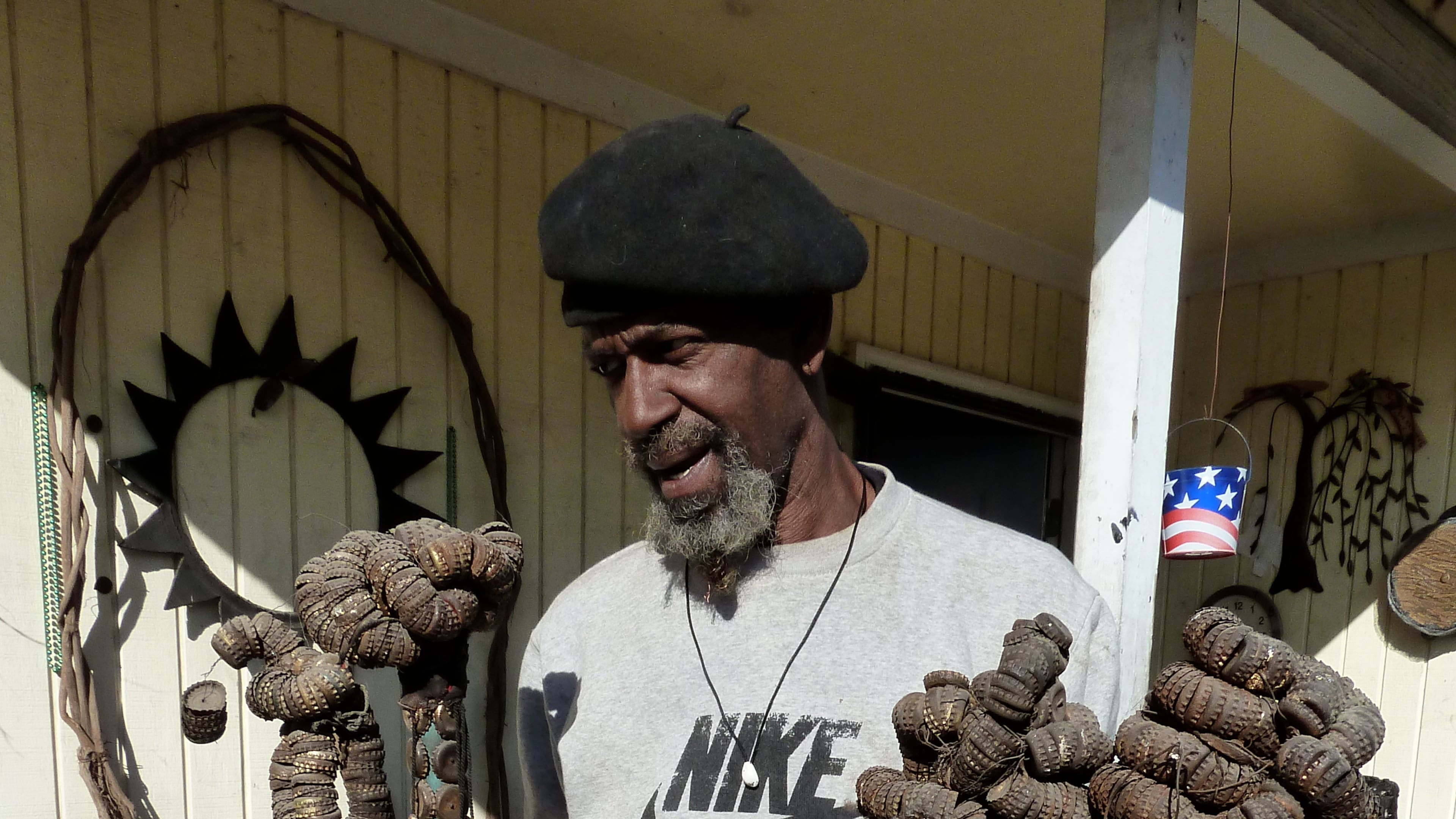 Mr. Imagination shows the three bottlecap staffs that survived the 2008 fire that leveled his home in Bethlehem, Penn.