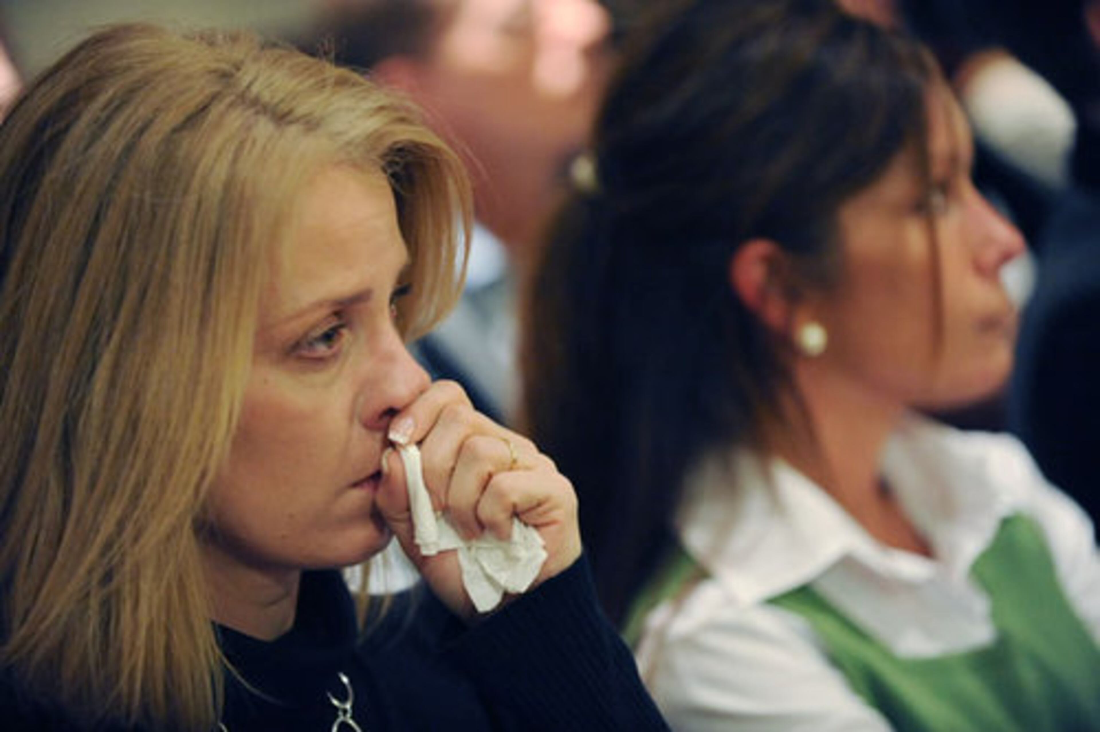 Allison Wilhelm (left), sister of slain federal agent David Wlihelm, and Candee Wilhelm, David Wilhelm's widow, watch testimony.