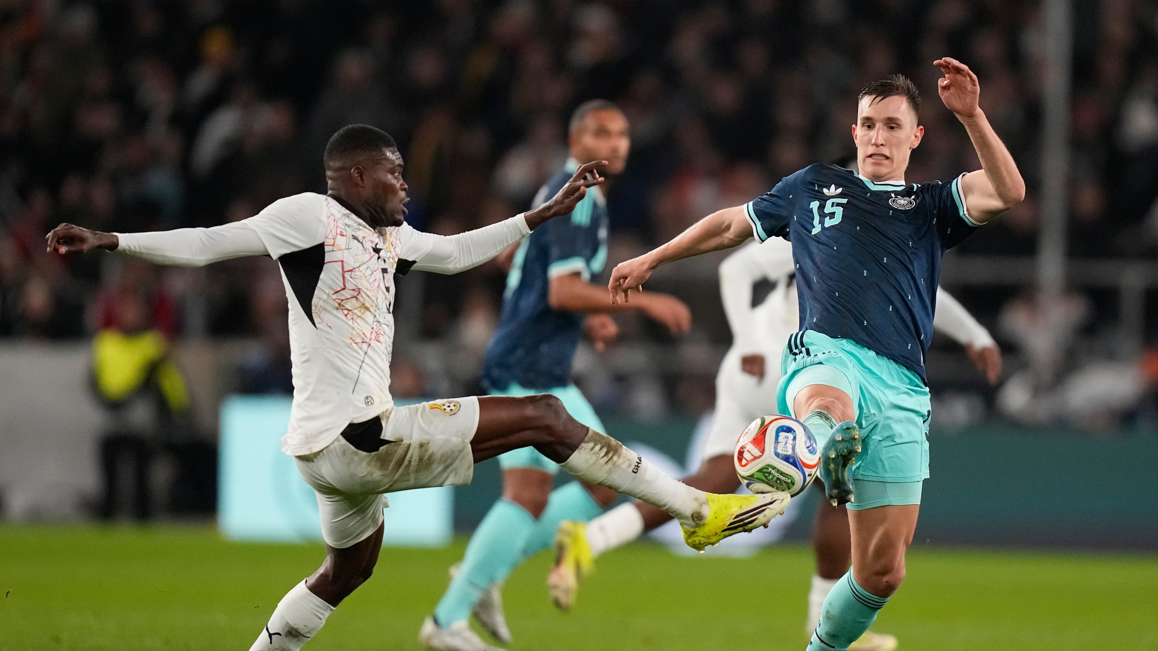 FILE -Thomas Partey of Ghana and Nico Schlotterbeck of Germany challenge for the ball during an international friendly soccer match between Germany and Ghana in Stuttgart, Germany, March 30, 2026. (AP Photo/Matthias Schrader, File)