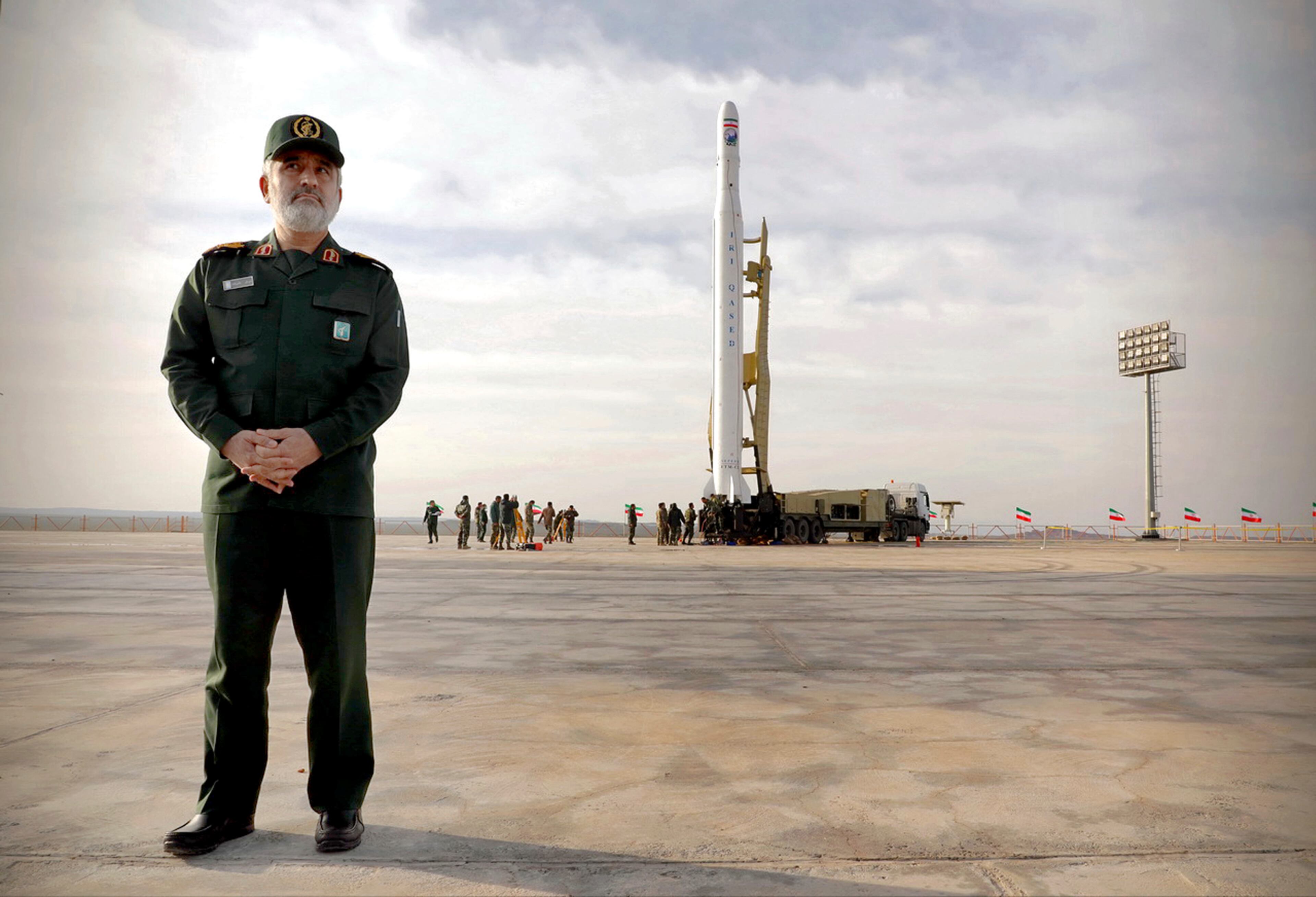 In this photo released by Sepahnews, Gen. Amir Ali Hajizadeh, the head of the Revolutionary Guard’s aerospace division, stands in front of an Iranian rocket carrying a satellite.