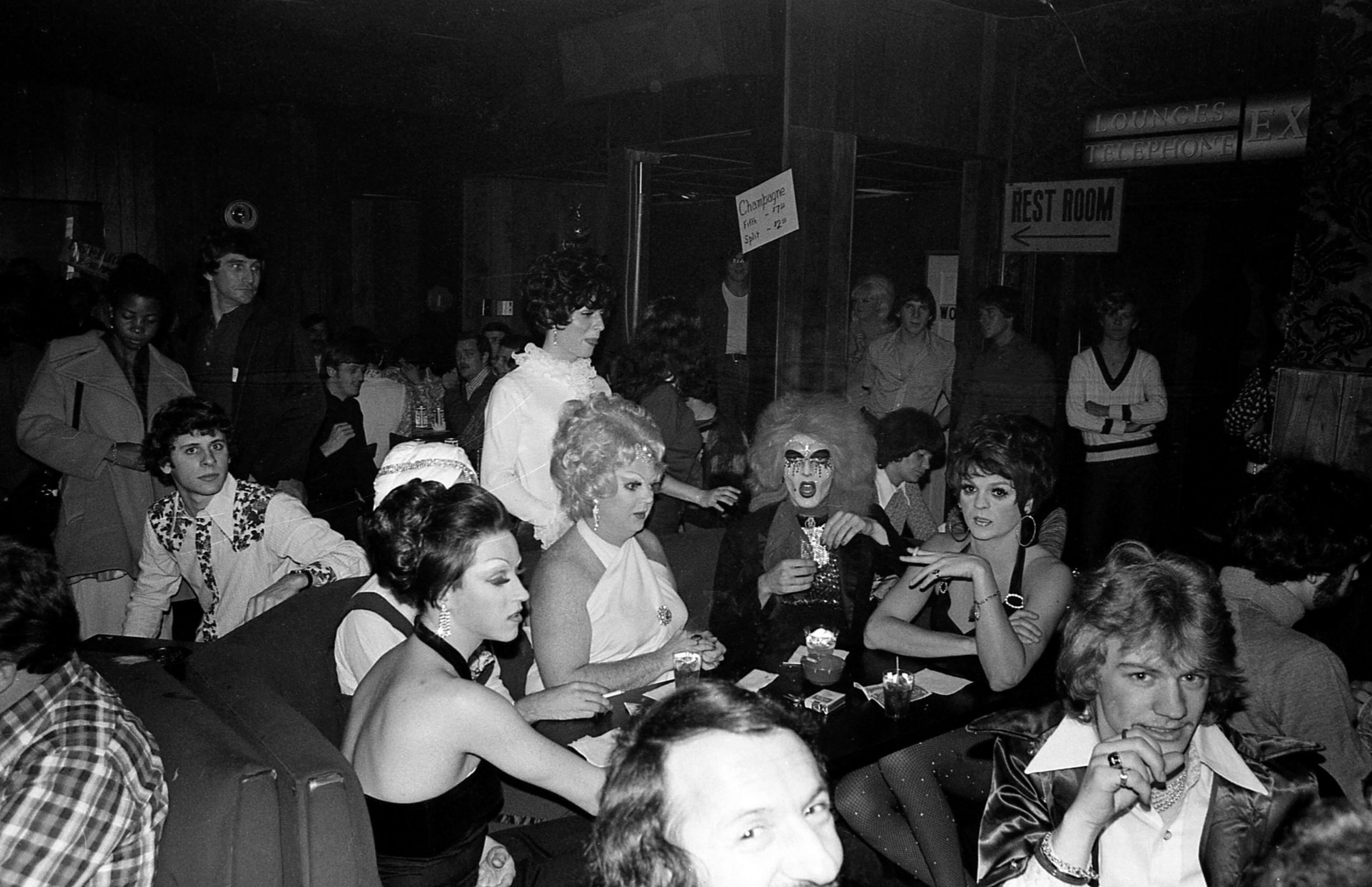 Midtown was the epicenter for the growing Gay Liberation movement, which led to a proliferation of Queer businesses, especially Gay bars, such as Bulldogs and the Armory; dance clubs, including Backstreet; and restaurants and lounges, such as the Prince George Inn. Drag queens in the audience of Sweet Gum Head cabaret on Cheshire Bridge await the appearance of Atlanta’s legendary performer Diamond Lil in 1971.