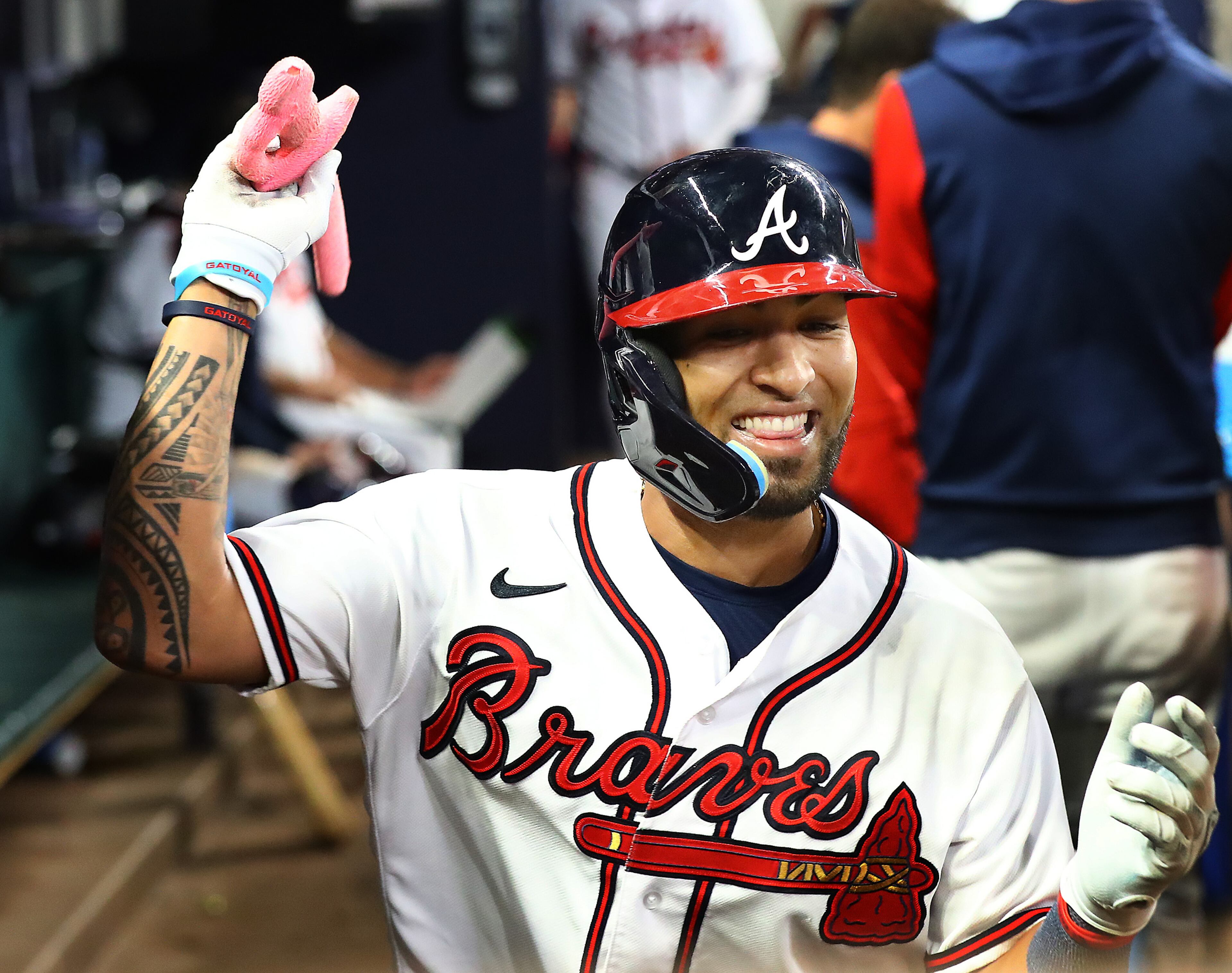 Braves outfielder Eddie Rosario is all smiles in the dugout after he hit a solo home run during the seventh inning against the Nationals on Monday night at Truist Park. (Curtis Compton / Curtis Compton@ajc.com)