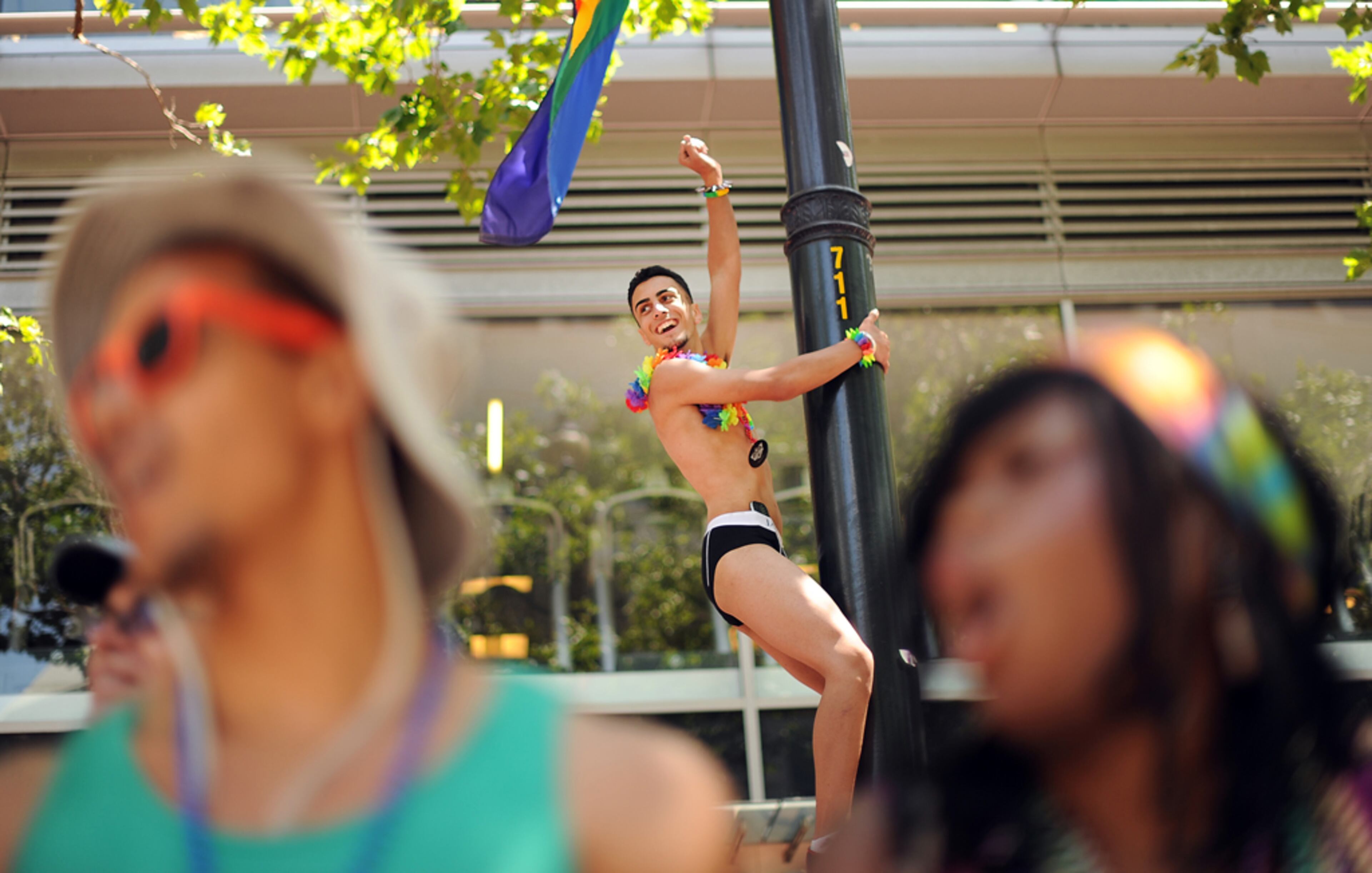 Faris Zumot dances on a light pole during San Francisco's 43rd annual Gay Pride parade on Sunday, June 30, 2013. (AP Photo/Noah Berger)