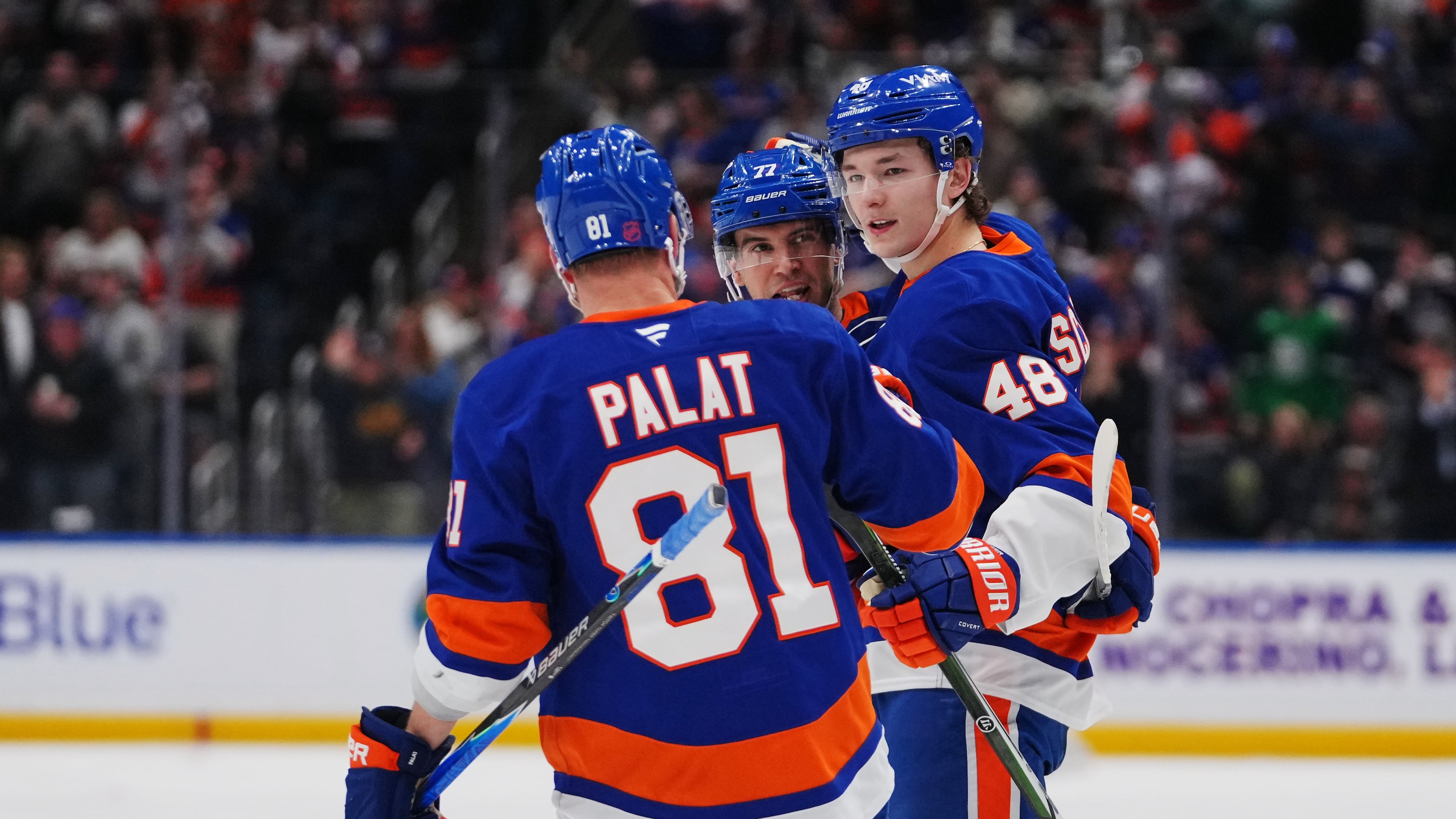 New York Islanders' Matthew Schaefer (48) celebrates with teammates Tony DeAngelo (77) andn Ondrej Palat (81) after scoring a goal during the second period of an NHL hockey game against the Toronto Maple Leafs Thursday, April 9, 2026, in Elmont, N.Y. (AP Photo/Frank Franklin II)
