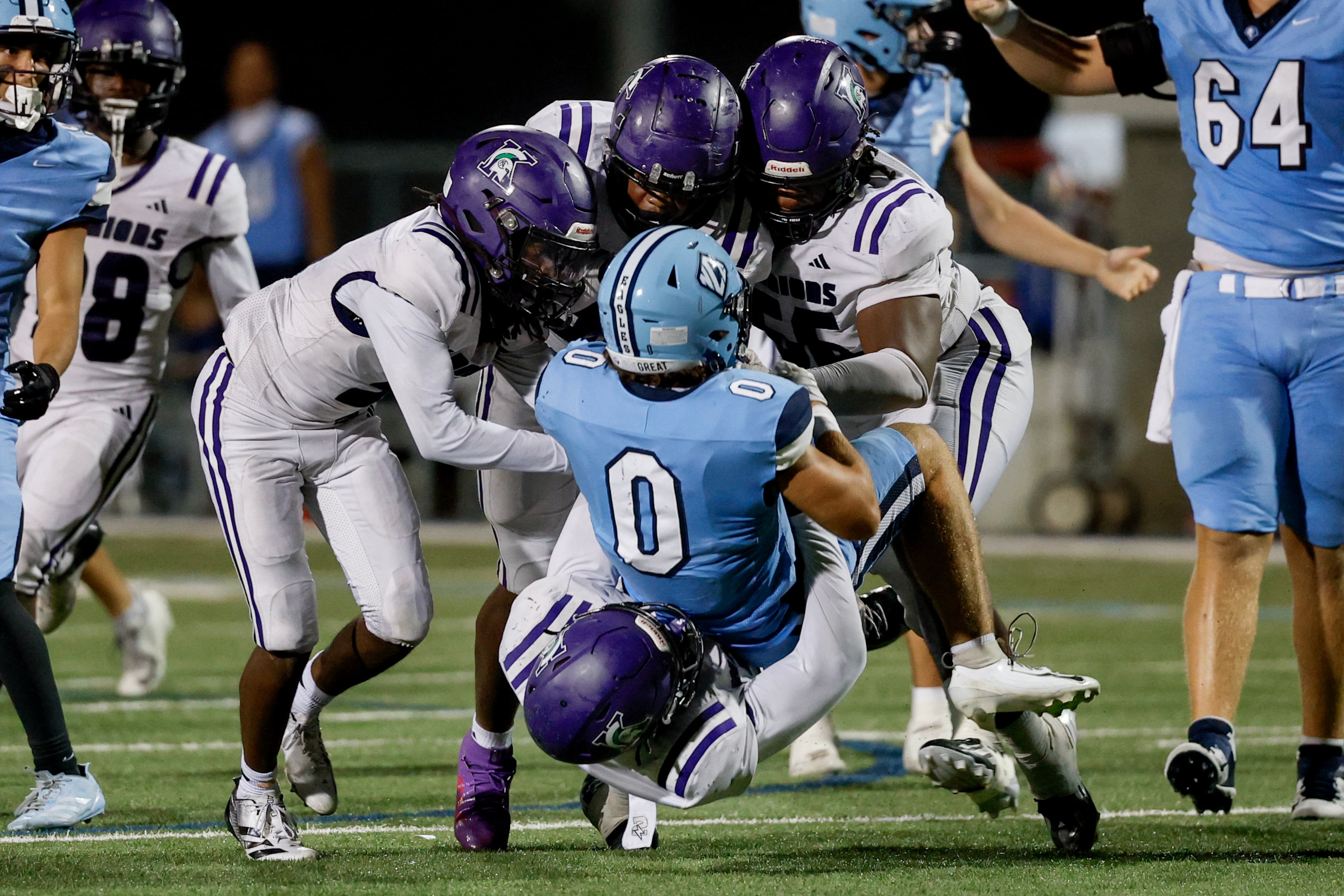 North Cobb Christian’s Jake Orton (center) is taken down by a host of KIPP Atlanta defenders during the second half of their game on Friday, Oct. 2, 2026, in Kennesaw. (Erik S. Lesser for the AJC)
