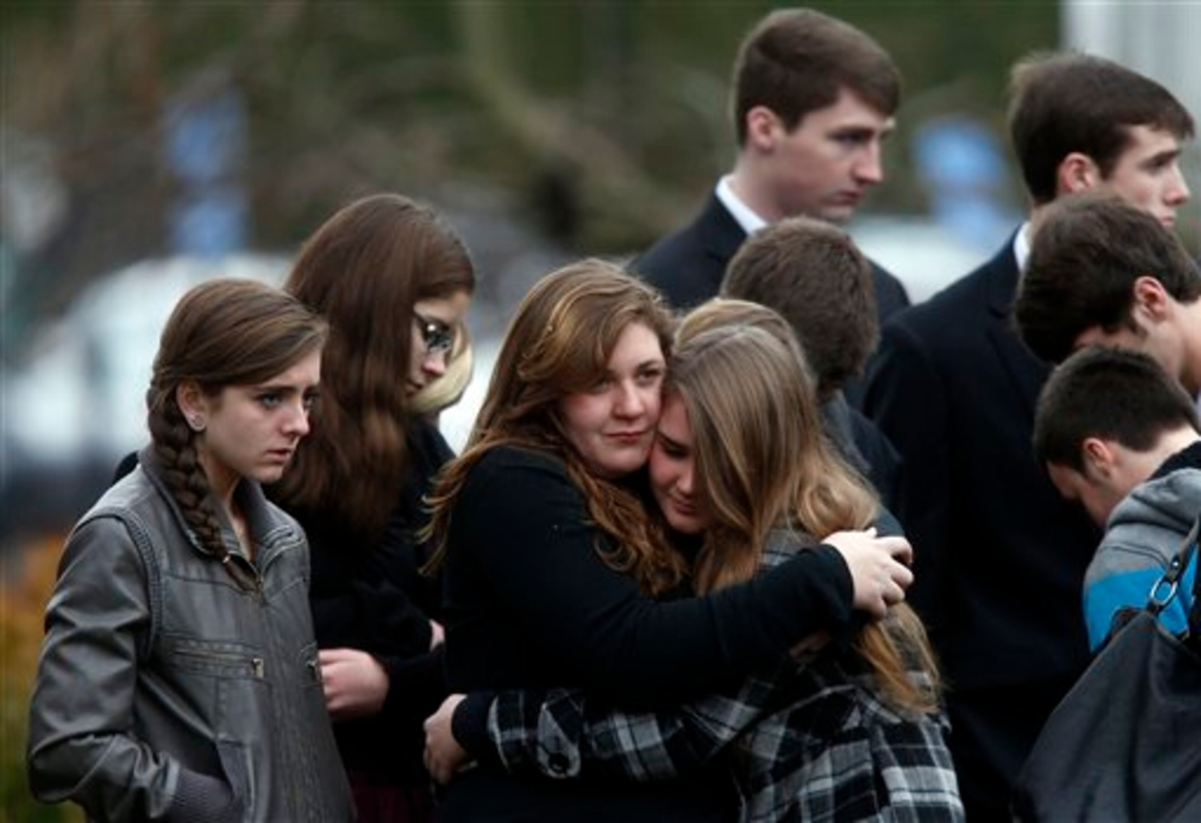 Mourners comfort one another as they leave a funeral service for 6-year-old Noah Pozner, Monday, Dec. 17, 2012, in Fairfield, Conn. Pozner was killed when a gunman walked into Sandy Hook Elementary School in Newtown Friday and opened fire, killing 26 people, including 20 children. (AP Photo/Jason DeCrow)