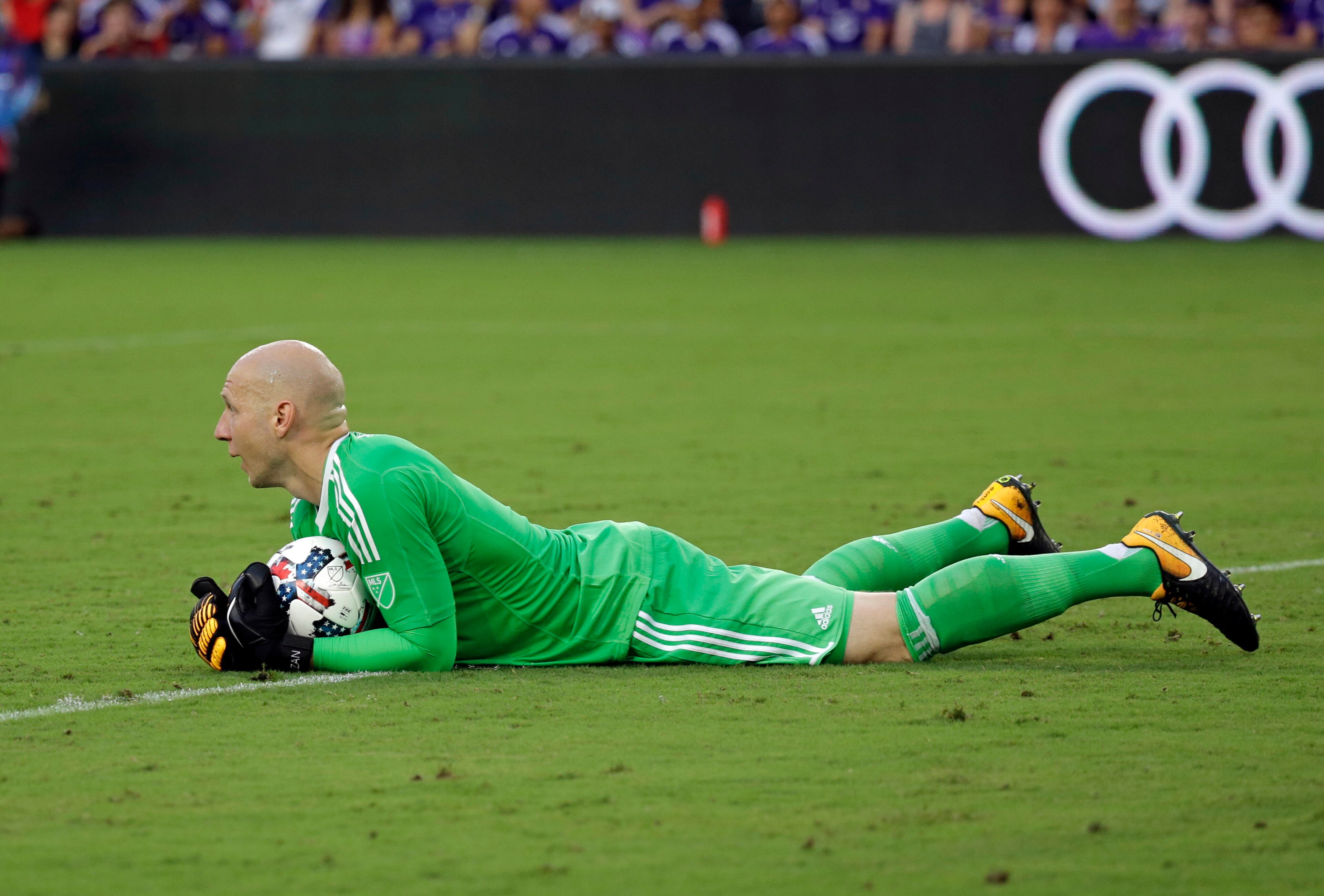 Atlanta United goalkeeper Brad Guzan blocks a shot during the first half of an MLS soccer match against Orlando City, Friday, July 21, 2017, in Orlando, Fla. (AP Photo/John Raoux)