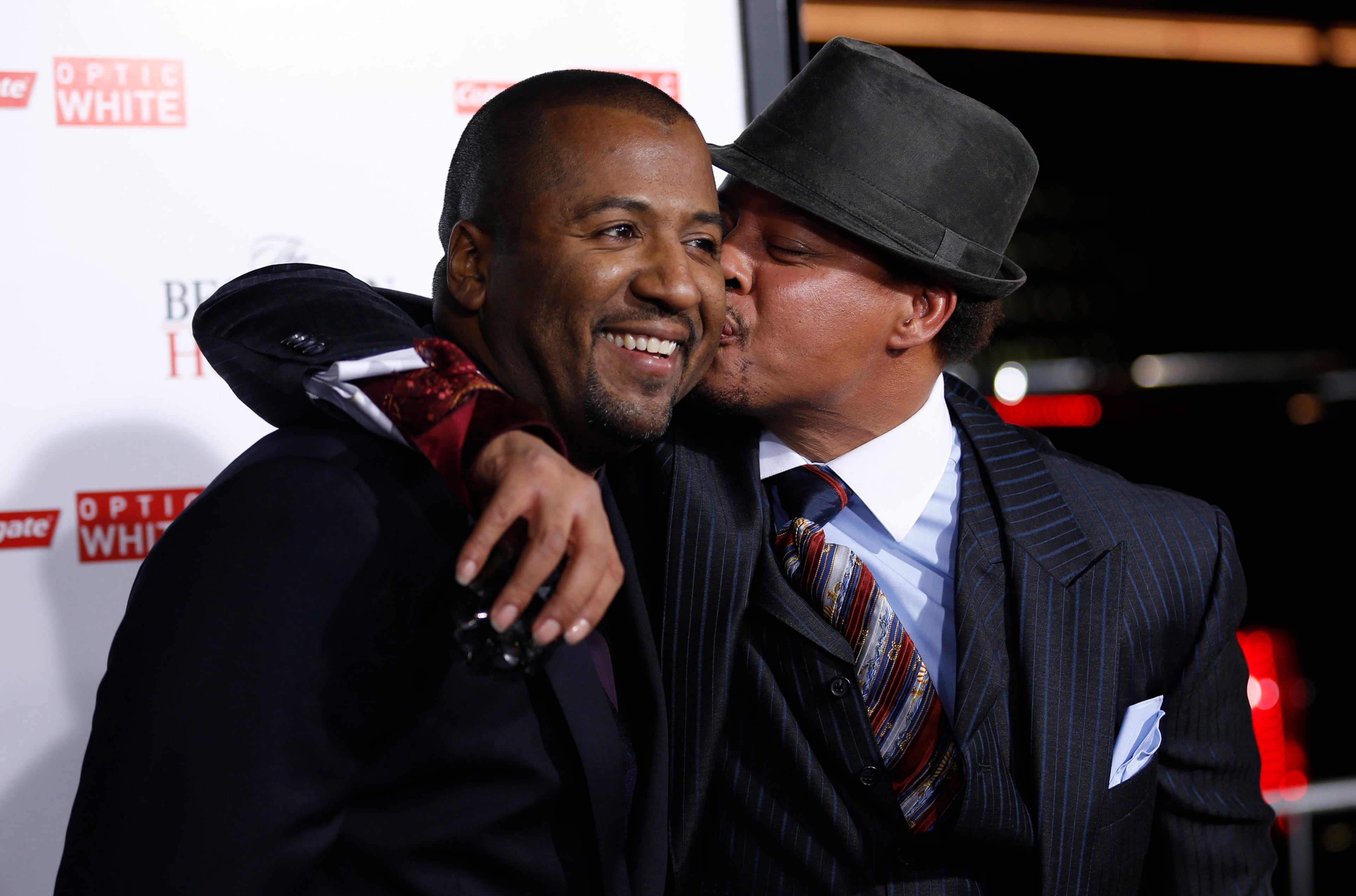 Director of the movie Malcolm D. Lee (L) gets a kiss on the cheek from cast member Terrence Howard at the premiere of "The Best Man Holiday" in Hollywood, California November 5, 2013. The movie opens in the U.S. on November 15.