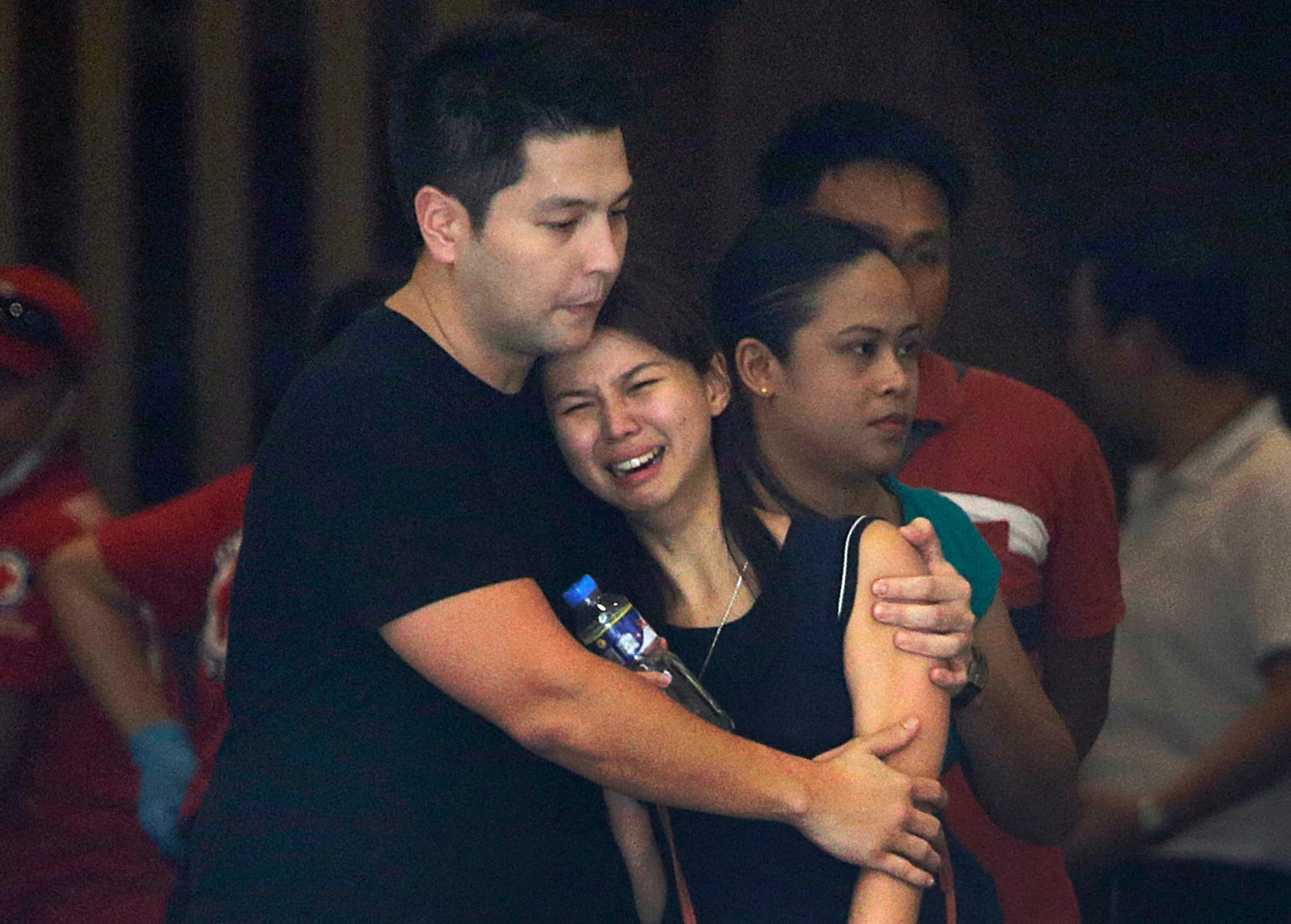 Relatives of victims grieve as they receive news of their loved ones at a hotel at the Resorts World Manila complex, Friday, June 2, 2017, in Manila, Philippines. Police say a gunman stormed a crowded Manila casino and used gasoline to set gambling tables on fire, creating clouds of smoke that swept through the crowds and killed dozens of people. (AP Photo/Aaron Favila)
